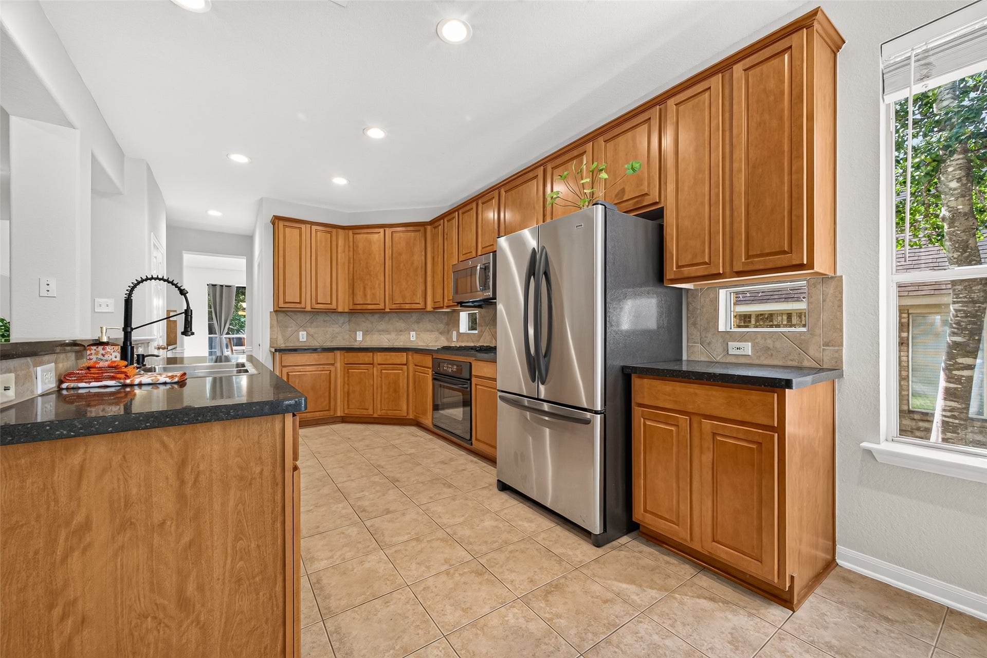 Well-appointed kitchen offering extensive cabinet storage, generous counter space, recessed lighting, and stainless steel appliances.
