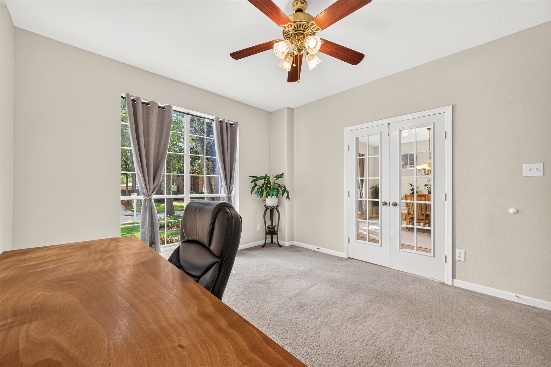 Another view of the home office highlighting the elegant French doors, offering privacy while maintaining a bright, open feel.