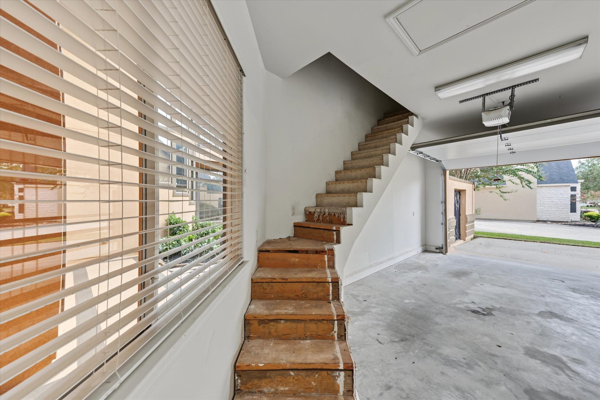 Stairs leading to floored garage space