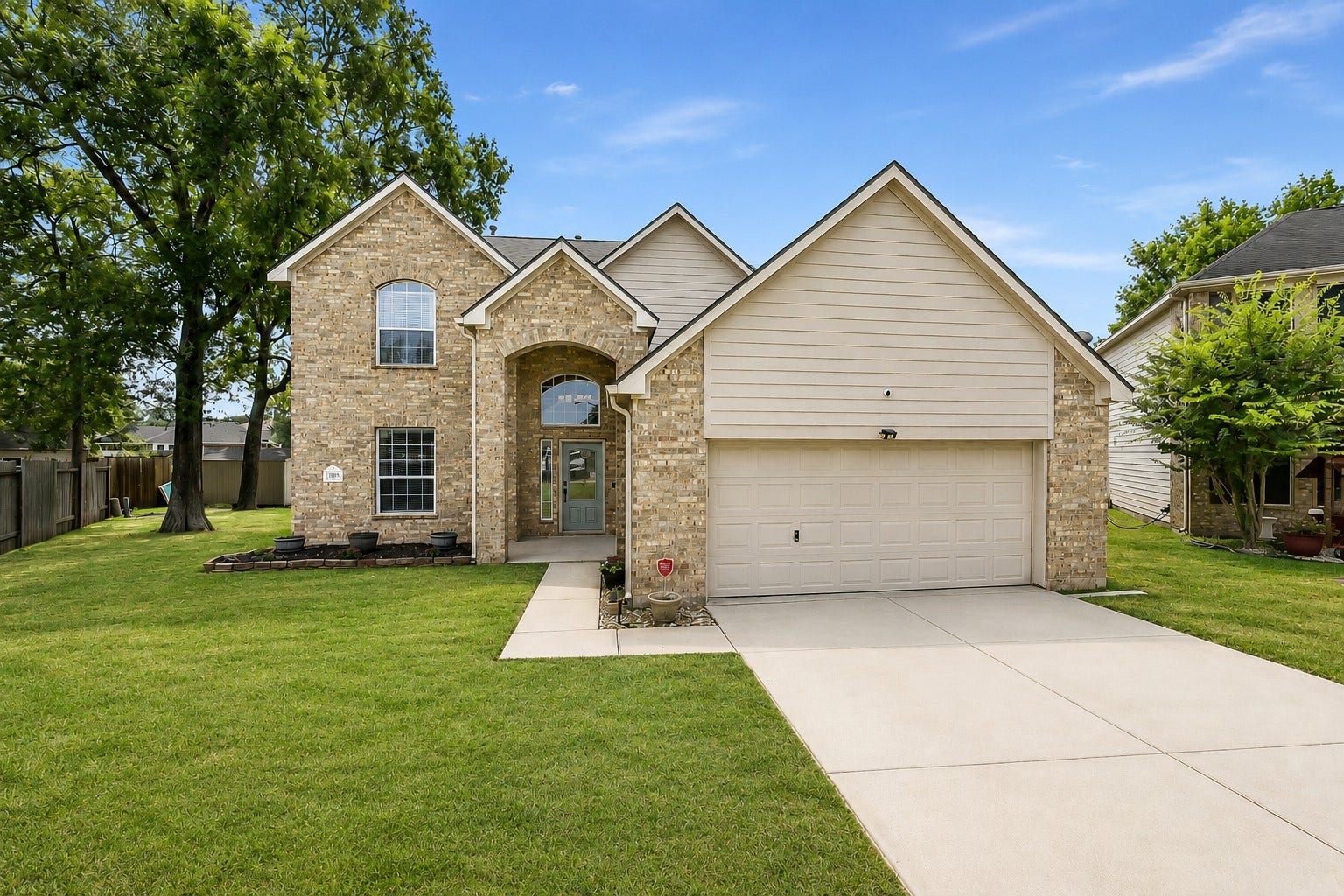 16806 Harbor Mist Court, Crosby, TX 77532 This is a two-story brick and siding home with a double garage. It features a well-maintained lawn, a welcoming front entrance, and mature trees on a quiet residential street.