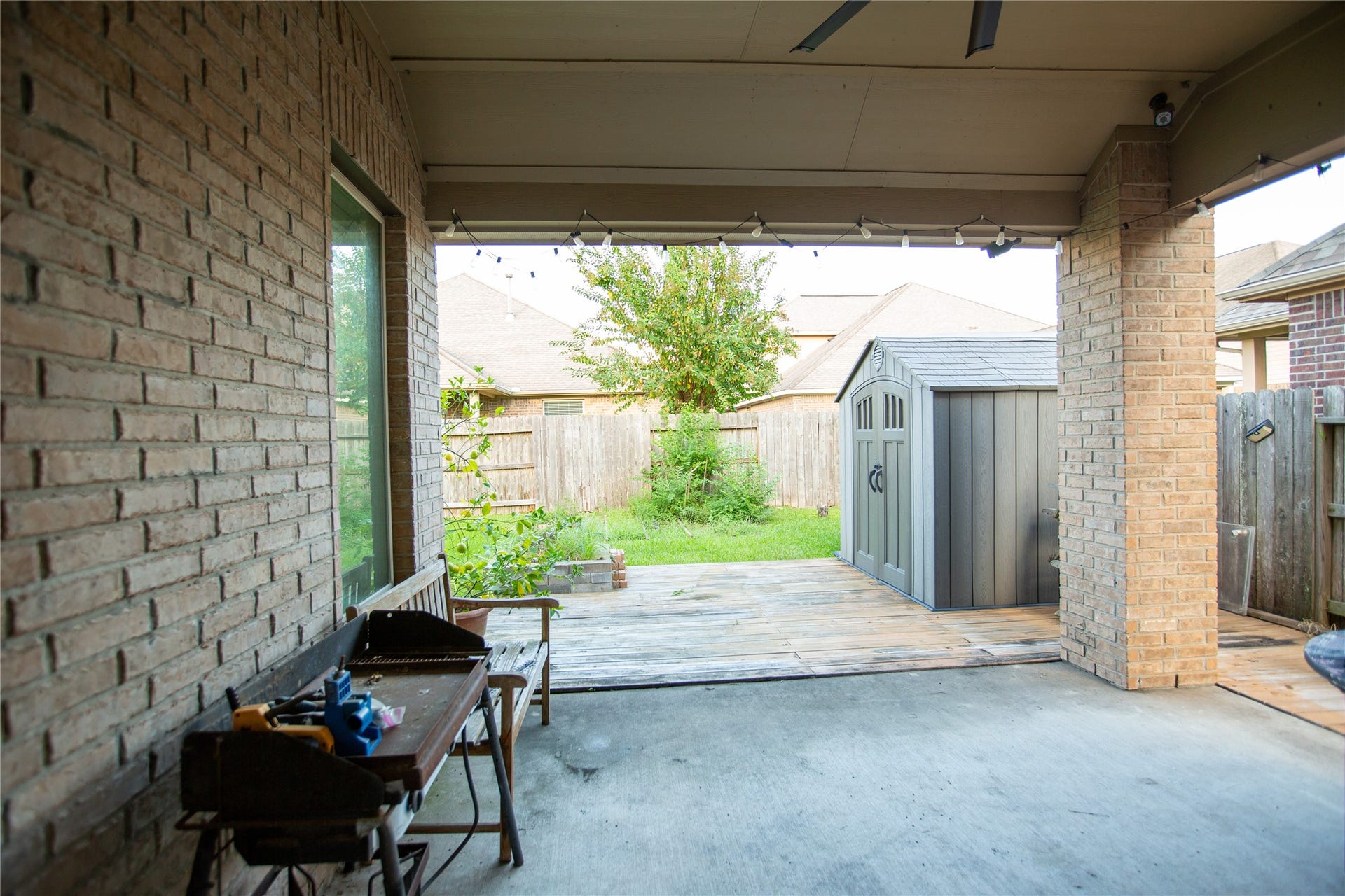 21014 Brunson Falls Drive, Richmond, TX 77407 Covered patio with wood decking outside