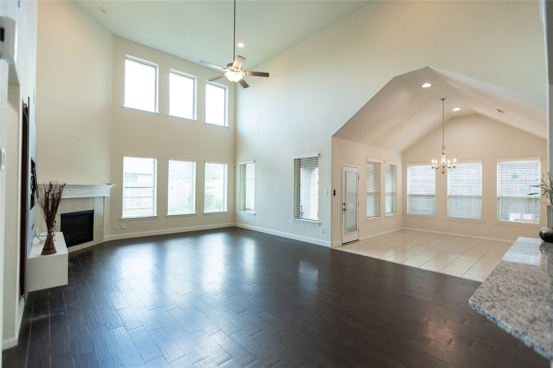 21014 Brunson Falls Drive, Richmond, TX 77407 Open living room with high ceilings connected to breakfast area
