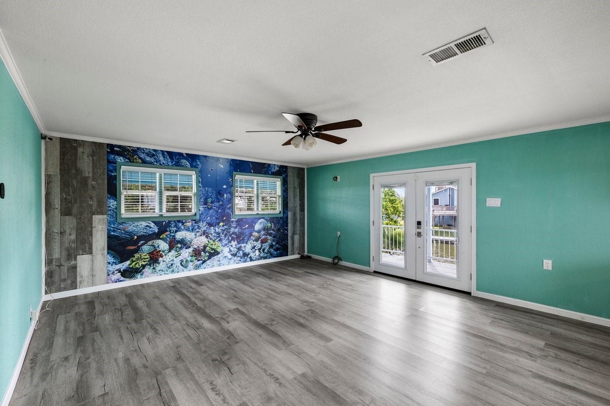 7210 Beau Terre Street, Hitchcock, TX 77563 Fish mural could easily be covered with shiplap, if it's not your style.