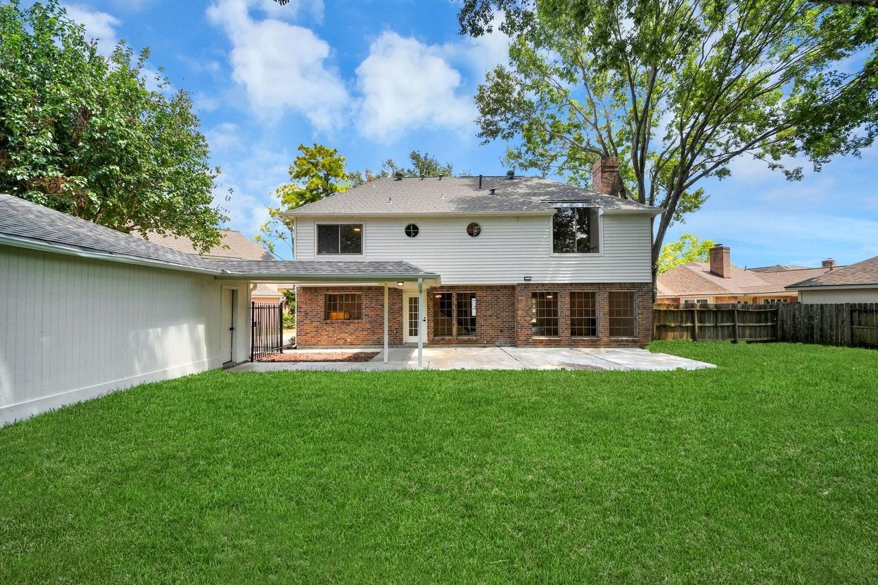 15047 Tramore Drive, Houston, TX 77083 The spacious backyard offers a wide expanse of freshly maintained lawn with mature trees providing shade and a peaceful backdrop. Designed for easy outdoor living, there's room to play, garden, entertain, or create your own private outdoor retreat.