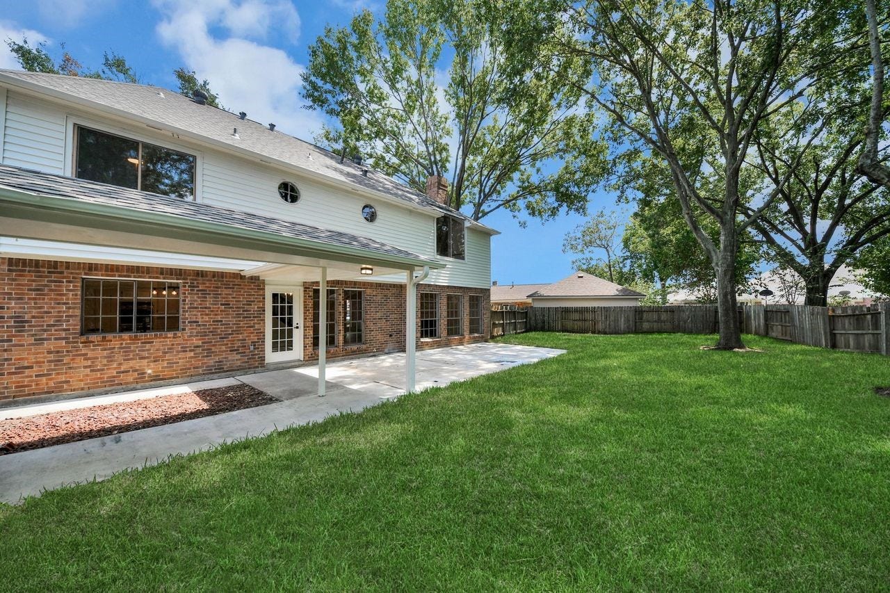 15047 Tramore Drive, Houston, TX 77083 A covered patio extends the living space outdoors, creating an inviting spot for relaxing or entertaining.