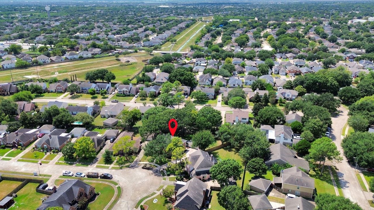 15047 Tramore Drive, Houston, TX 77083 Pulling back even farther reveals the home's place within the surrounding community and the thoughtful scale of the property.