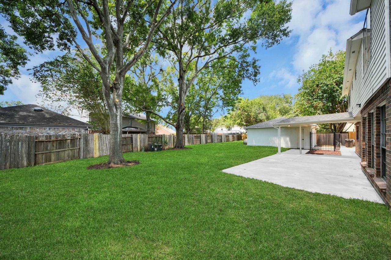 15047 Tramore Drive, Houston, TX 77083 There's plenty of room to enjoy the outdoors, with lush green lawn, mature trees, and a large patio area ready for gatherings or quiet afternoons.