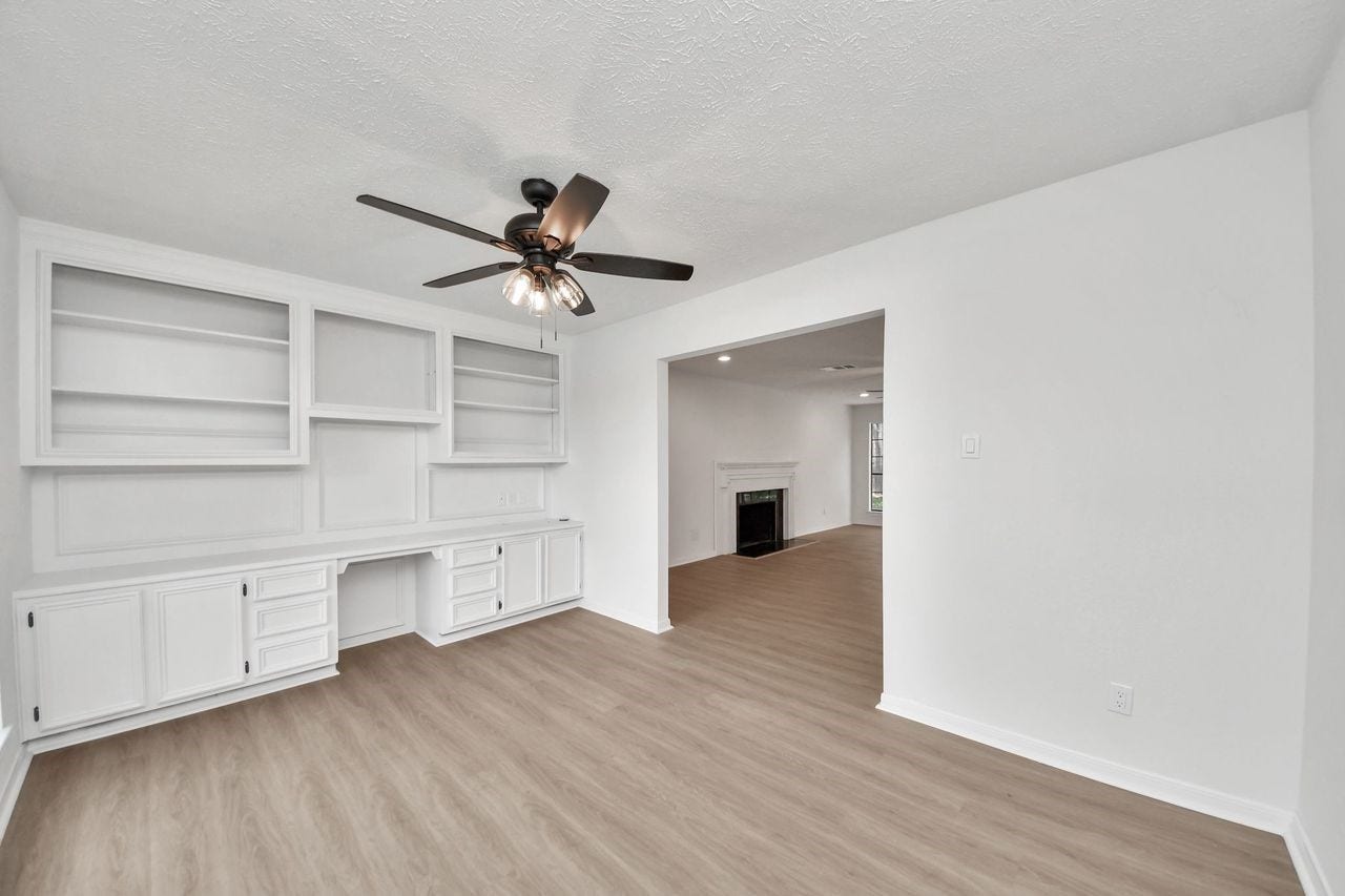 15047 Tramore Drive, Houston, TX 77083 Custom built-ins provide generous storage and display space, creating a polished office that can easily double as a study, library, homework room, or creative space.