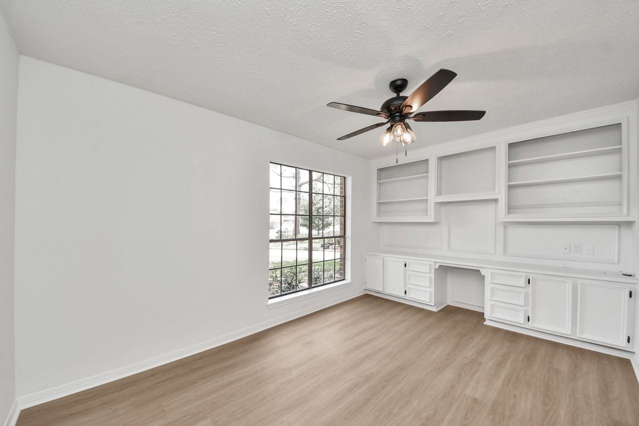 15047 Tramore Drive, Houston, TX 77083 Work from home without sacrificing style or space. Built-in cabinetry, shelving, and a dedicated workspace give this room the organization needed for productive days, while the oversized window keeps the atmosphere bright and inviting.