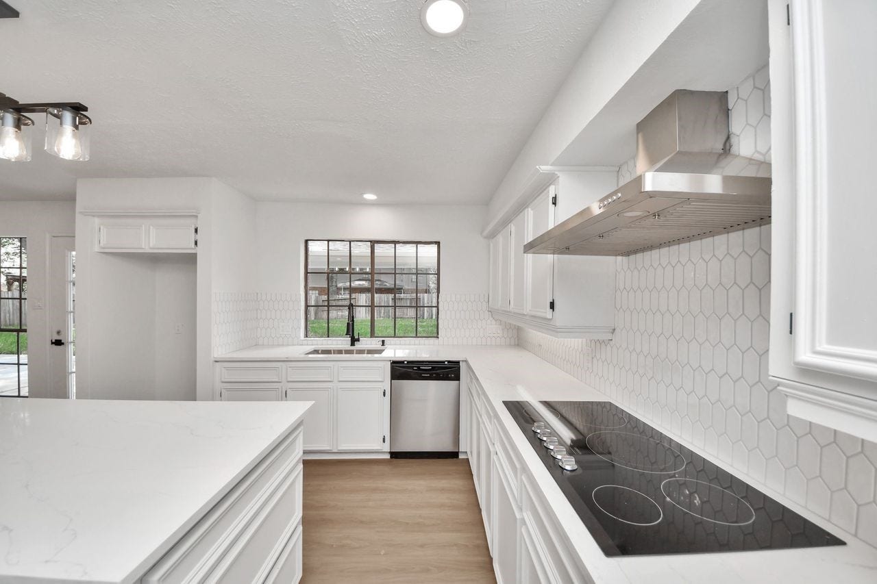 15047 Tramore Drive, Houston, TX 77083 A large window above the kitchen sink fills the space with natural light and provides a pleasant view of the backyard.