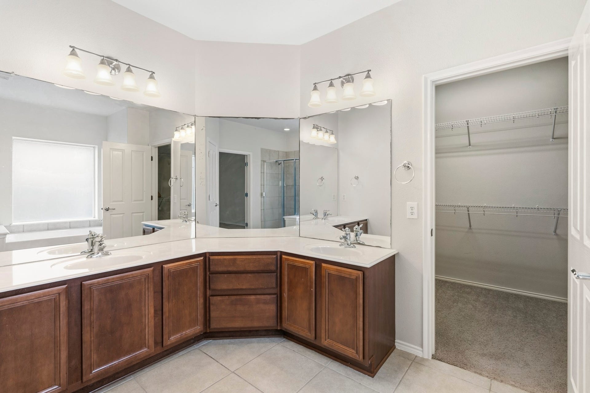 5515 Granite Meadow Drive, Katy, TX 77494 Additional view of the primary bath showcasing extensive storage, dual vanity space, and convenient access to the oversized walk-in closet.