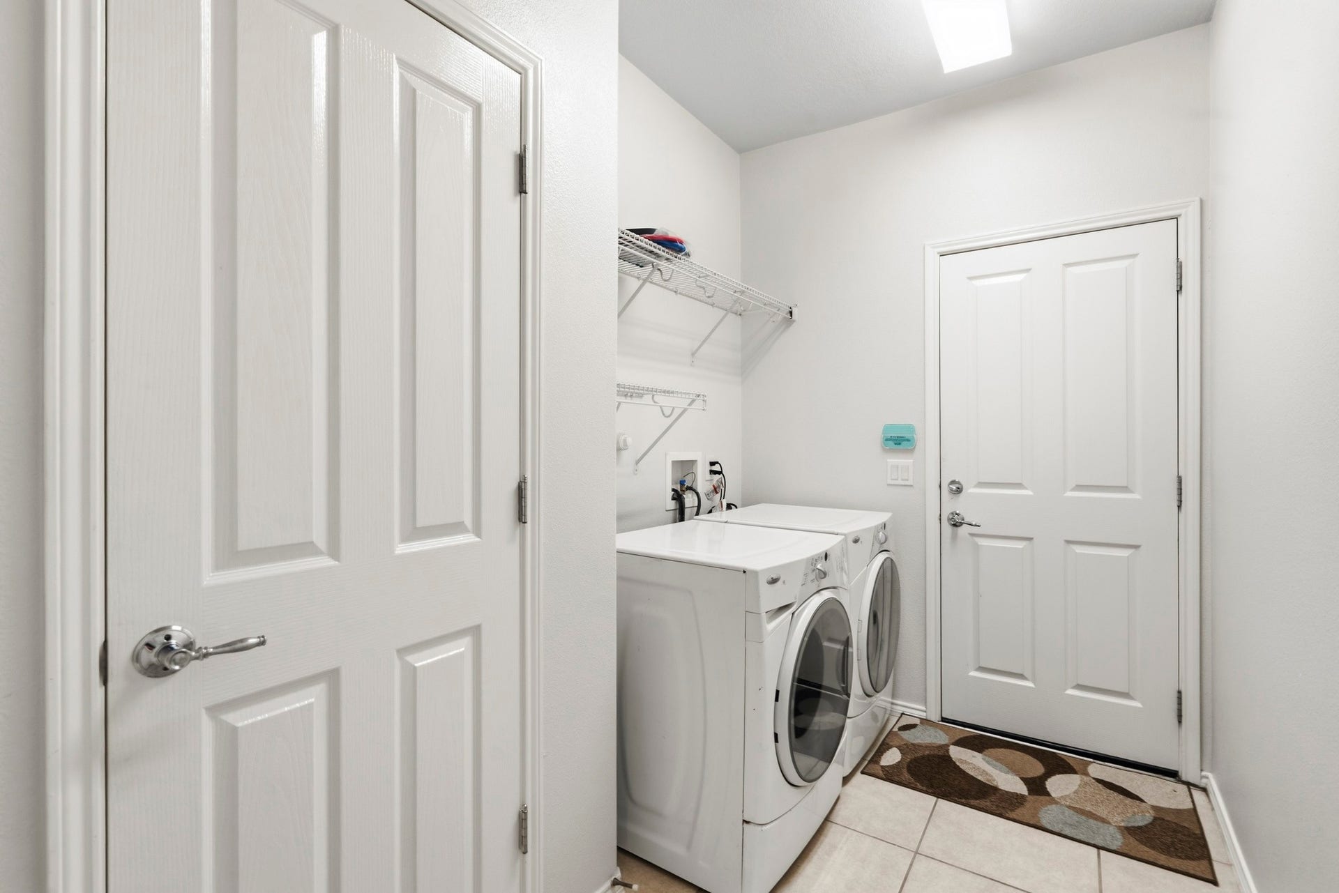 5515 Granite Meadow Drive, Katy, TX 77494 Generously sized utility room featuring included front-load washer and dryer, plus an impressive walk-in storage closet for exceptional organization.