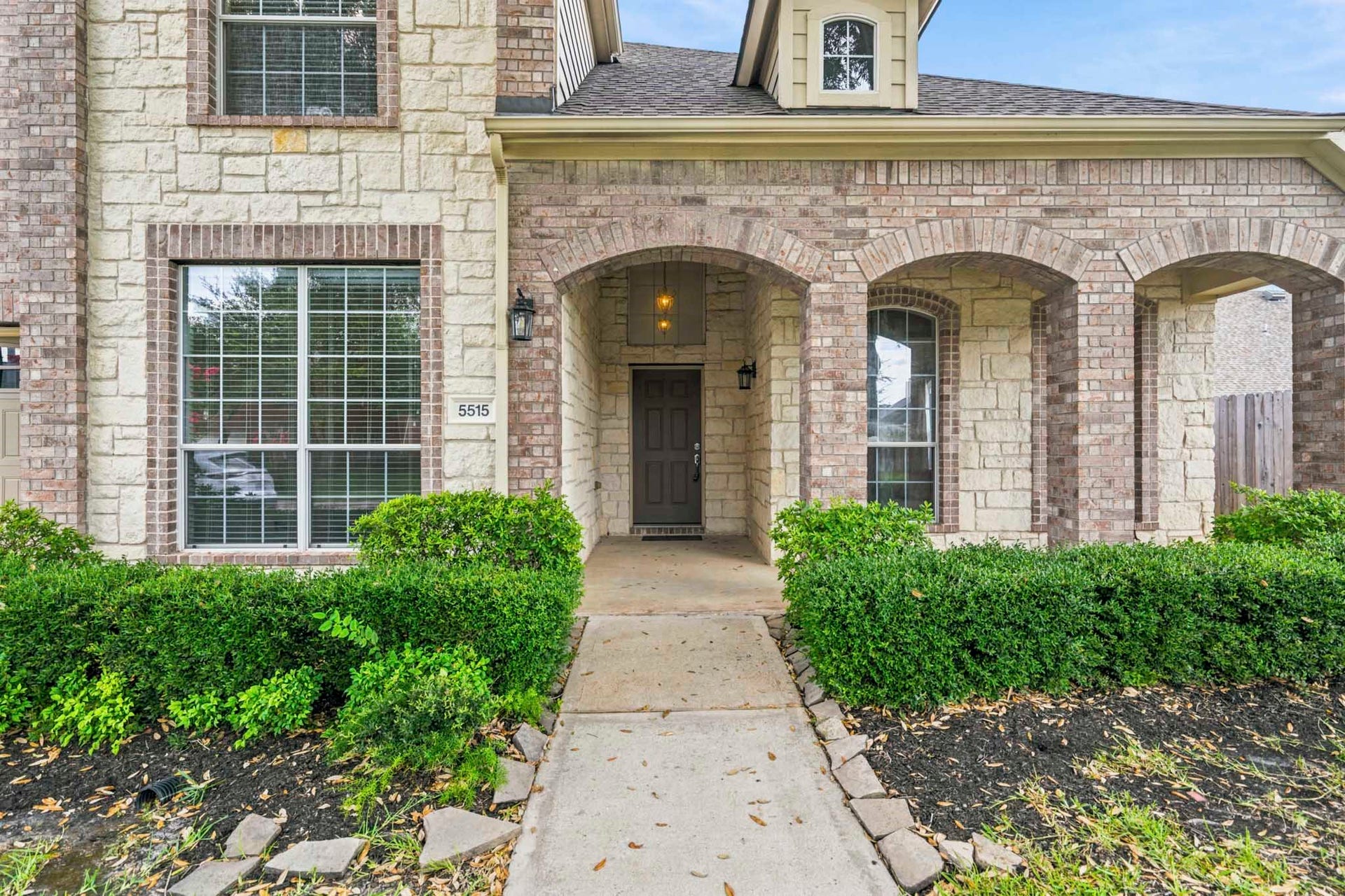 5515 Granite Meadow Drive, Katy, TX 77494 Another view of the charming covered front porch, showcasing the home's beautiful landscaping and inviting entrance.