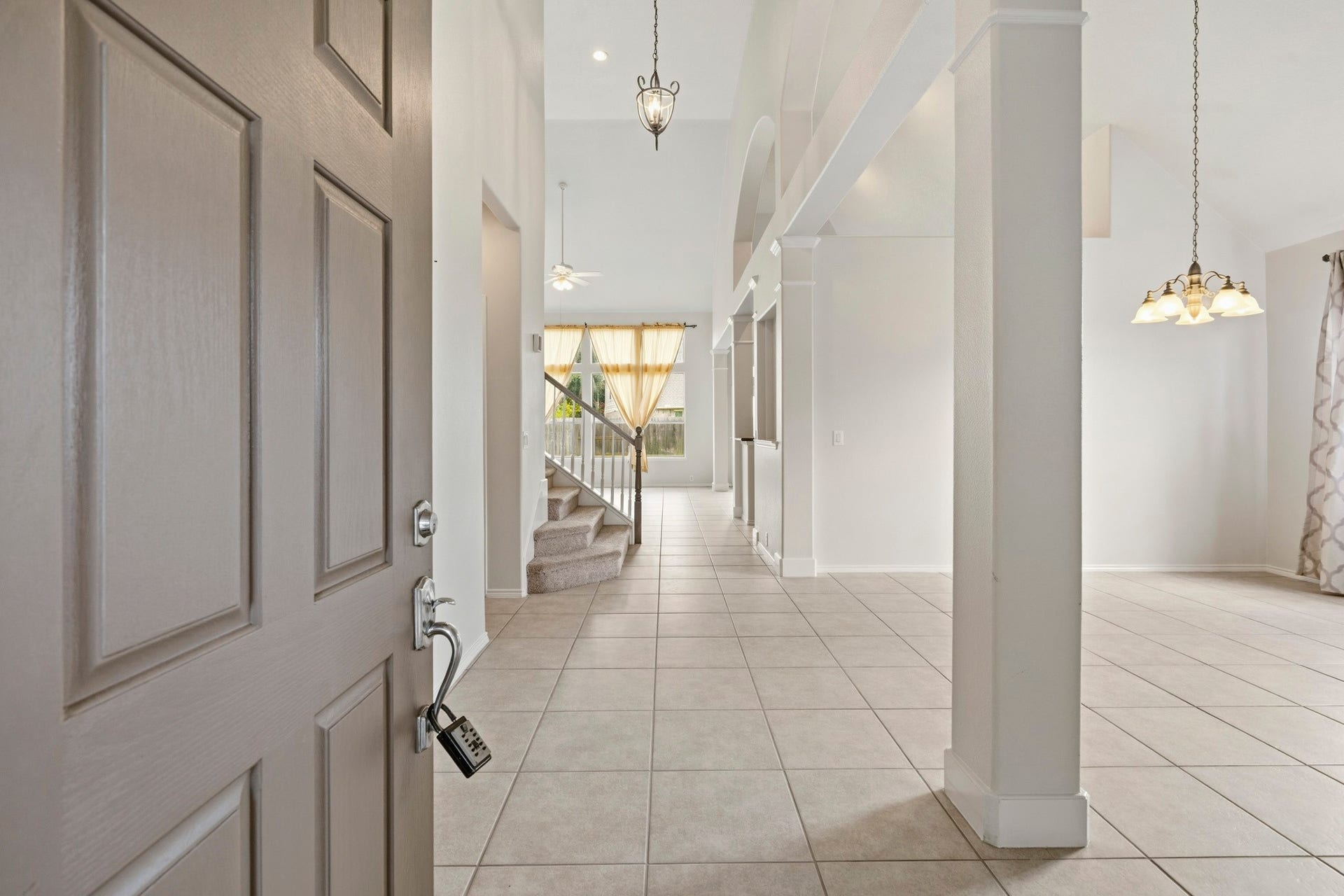 5515 Granite Meadow Drive, Katy, TX 77494 Elegant tiled entryway offering a warm welcome and beautiful sightlines into the formal living and dining areas.