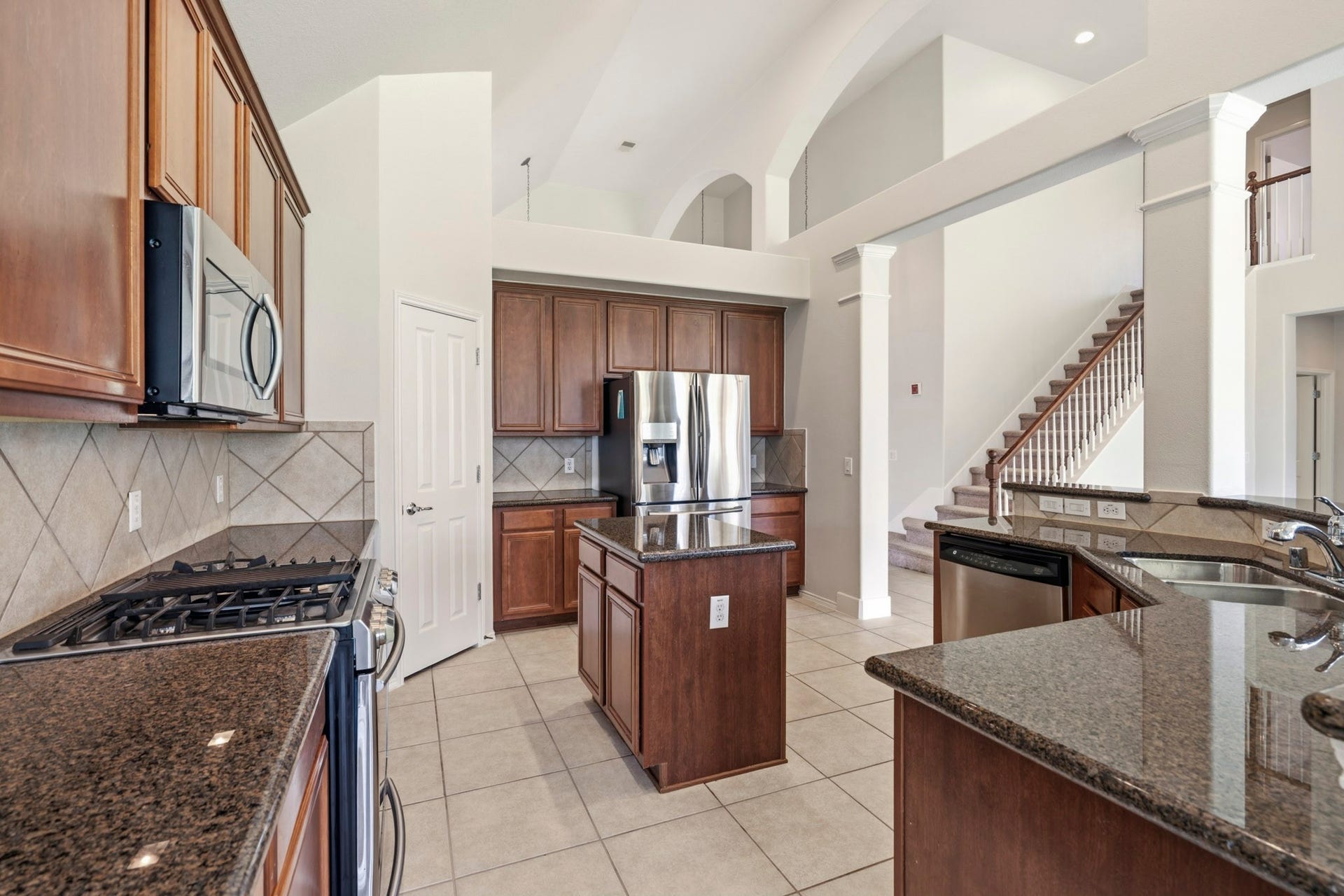 5515 Granite Meadow Drive, Katy, TX 77494 Large island kitchen offering abundant cabinetry, generous counter space, and excellent storage for all your culinary needs.