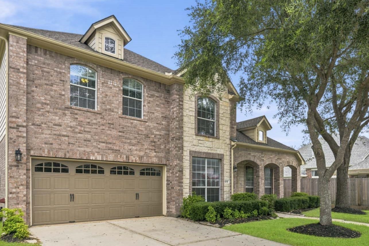 5515 Granite Meadow Drive, Katy, TX 77494 Spacious two-car garage featuring durable epoxy flooring, providing both functionality and a clean, polished appearance.