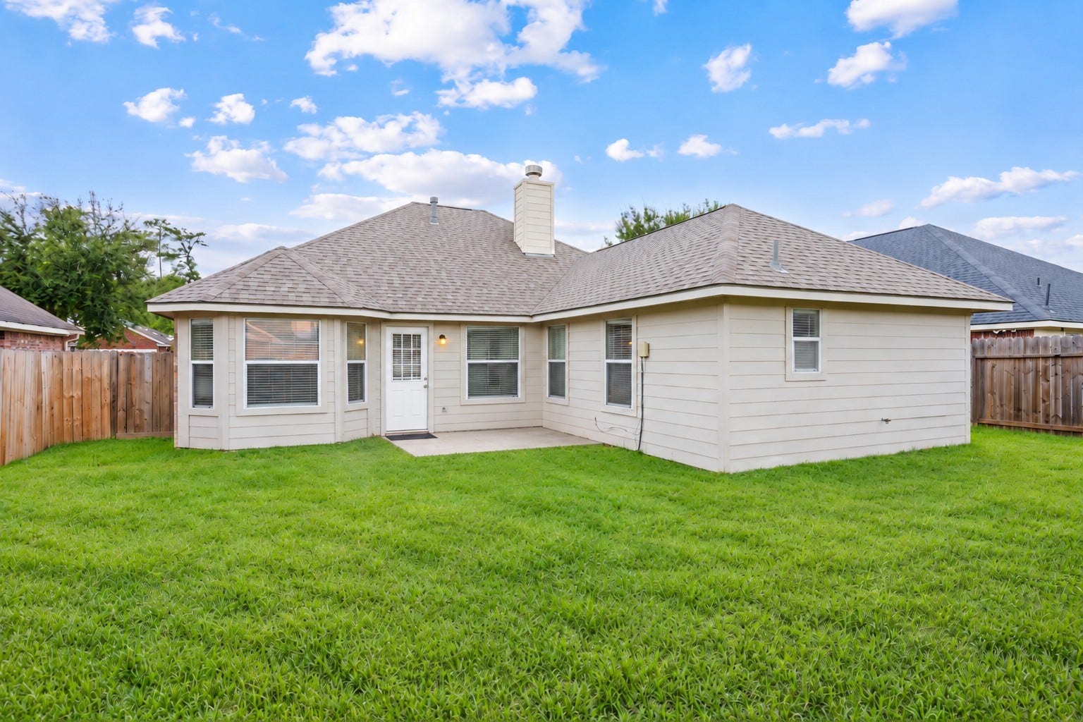 Fenced backyard with covered patio area, spacious lawn, and room for outdoor entertaining.
***Virtually Enhanced Photo***