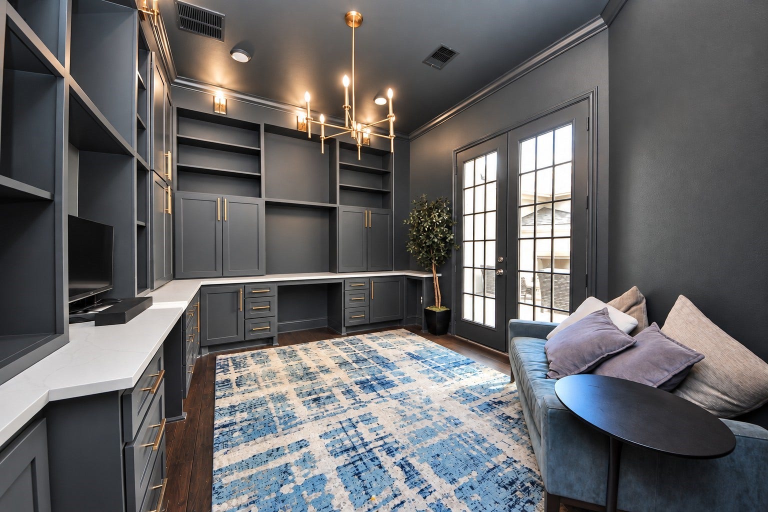 12821 N Palomino Lake Circle, Cypress, TX 77429 Sophisticated private study featuring rich, dark finishes, custom built-in cabinetry with soft-close drawers, two dedicated workstations, an elegant chandelier, and double doors opening to the private courtyard.