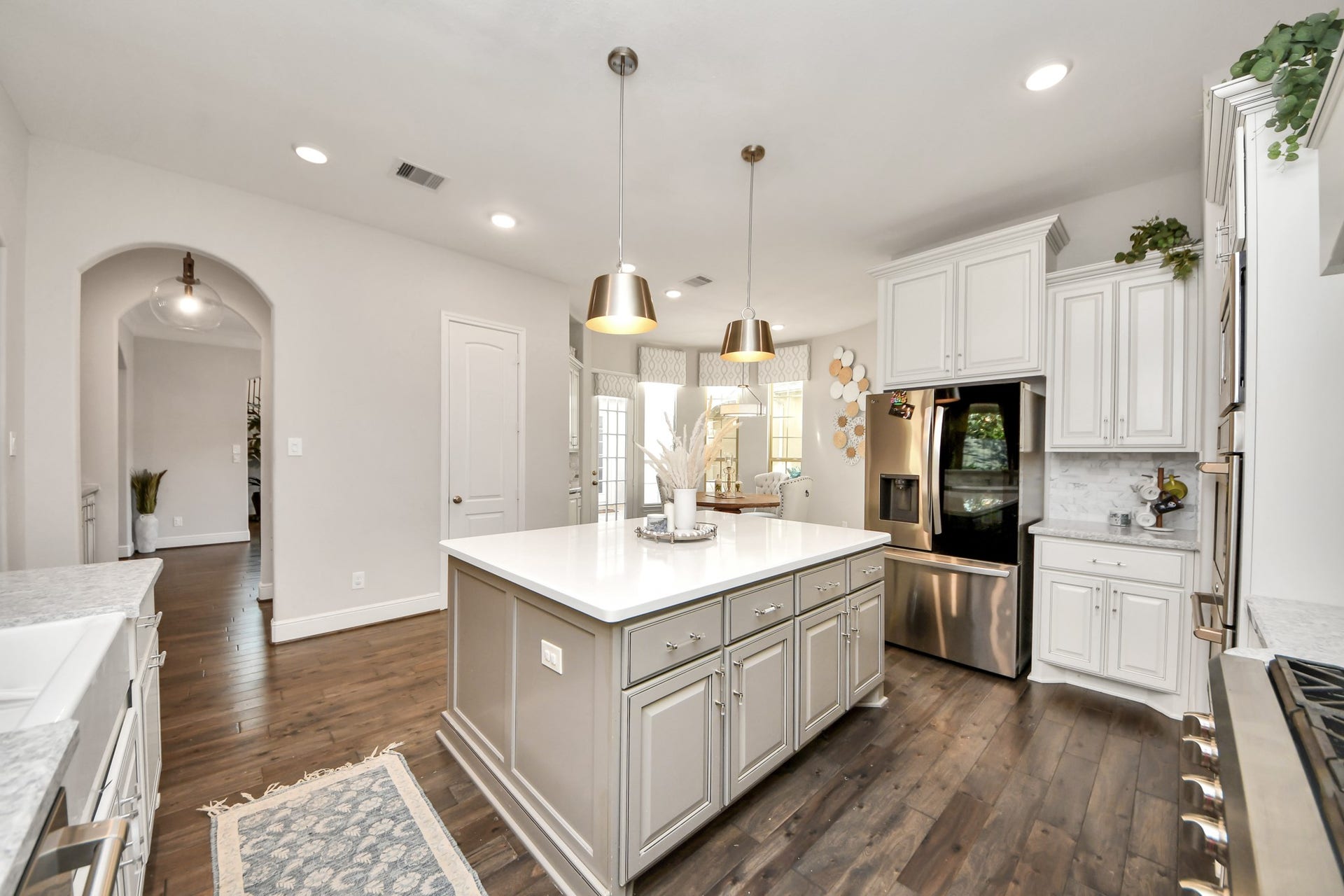 12821 N Palomino Lake Circle, Cypress, TX 77429 Another view of the gourmet kitchen overlooking the breakfast area, featuring a spacious center island, walk-in pantry, and convenient butler's pantry with additional cabinetry and countertop space.