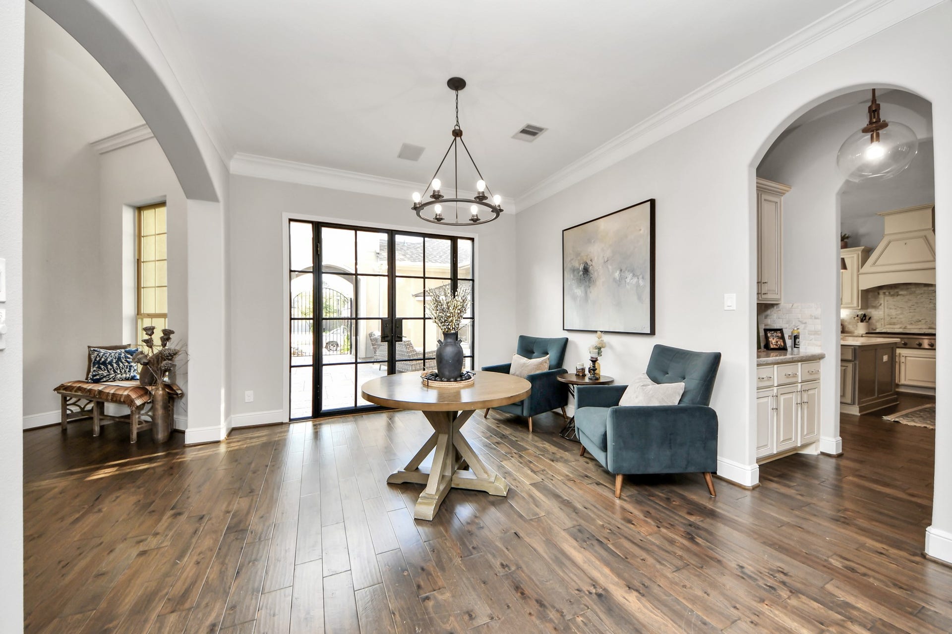 12821 N Palomino Lake Circle, Cypress, TX 77429 Grand entry foyer featuring elegant arched openings, beautiful hardwood flooring, built-in surround sound speakers, and an open, inviting layout that welcomes you into the home.