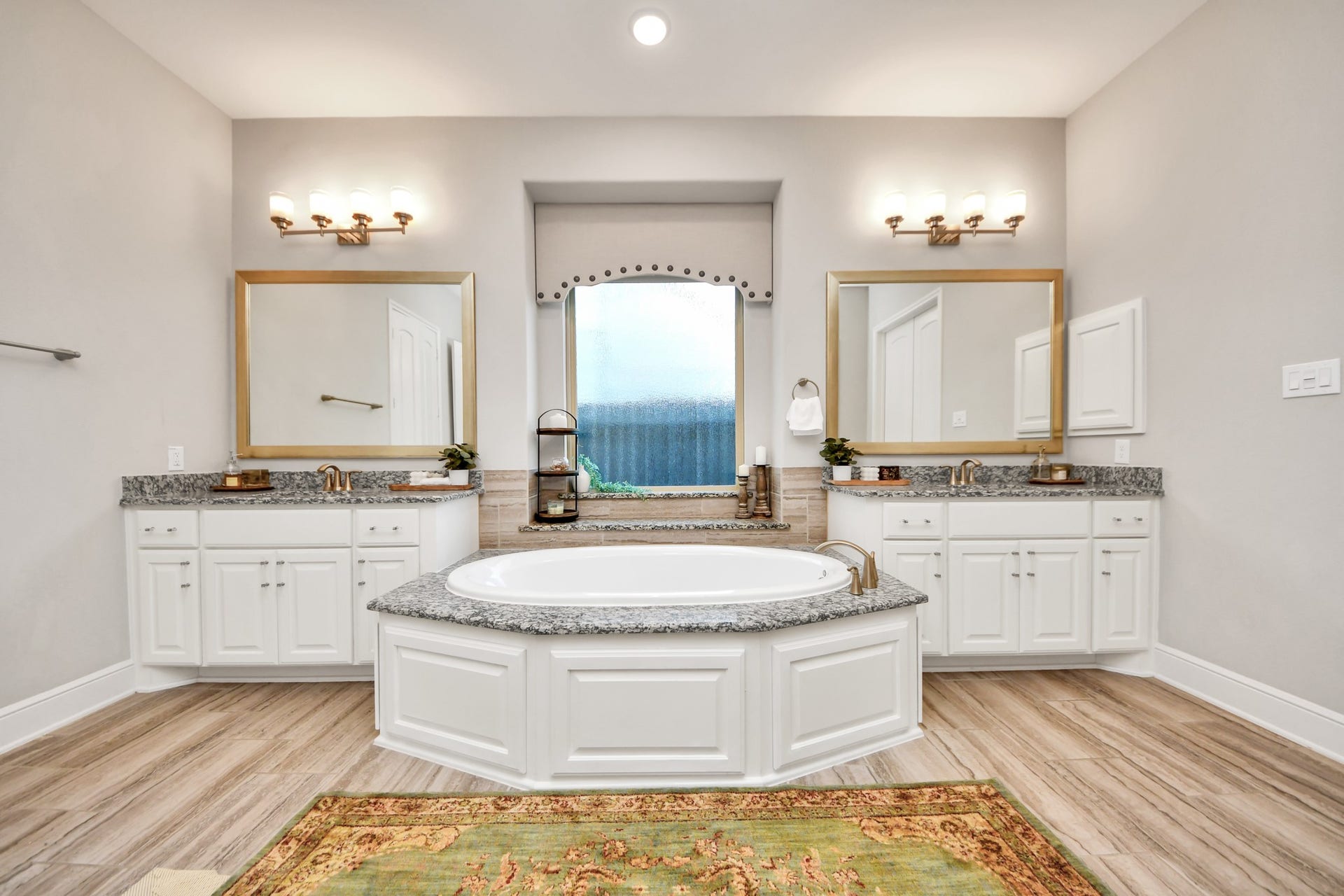 12821 N Palomino Lake Circle, Cypress, TX 77429 Spacious primary bathroom featuring a stunning 6-foot soaking tub, separate vanities with granite countertops, custom cabinetry, and an open, luxurious layout.