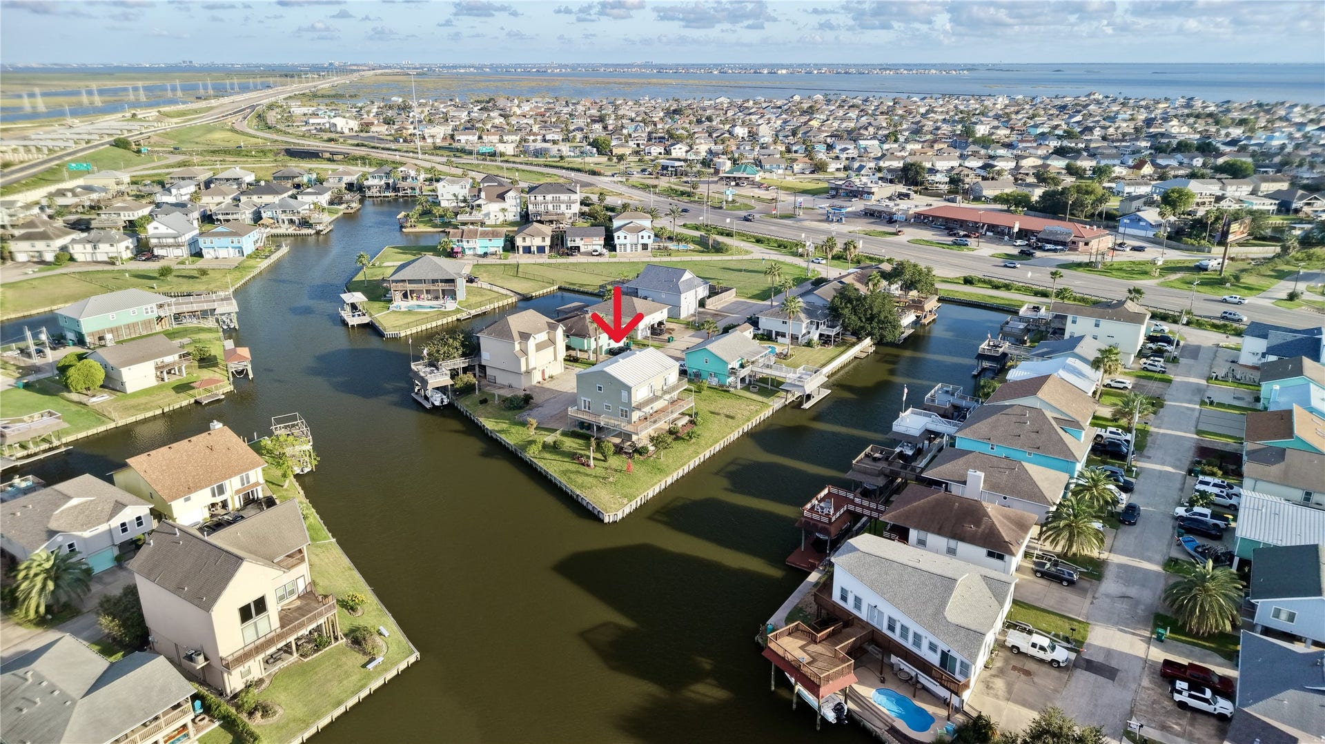 7 S Skimmer Street, La Marque, TX 77568 Aerial view of Omega Bay's canal community, with deep-water canals leading out to Galveston Bay. The Galveston Causeway, open bay views, and nearby shopping and dining along I-45 are all just minutes away.