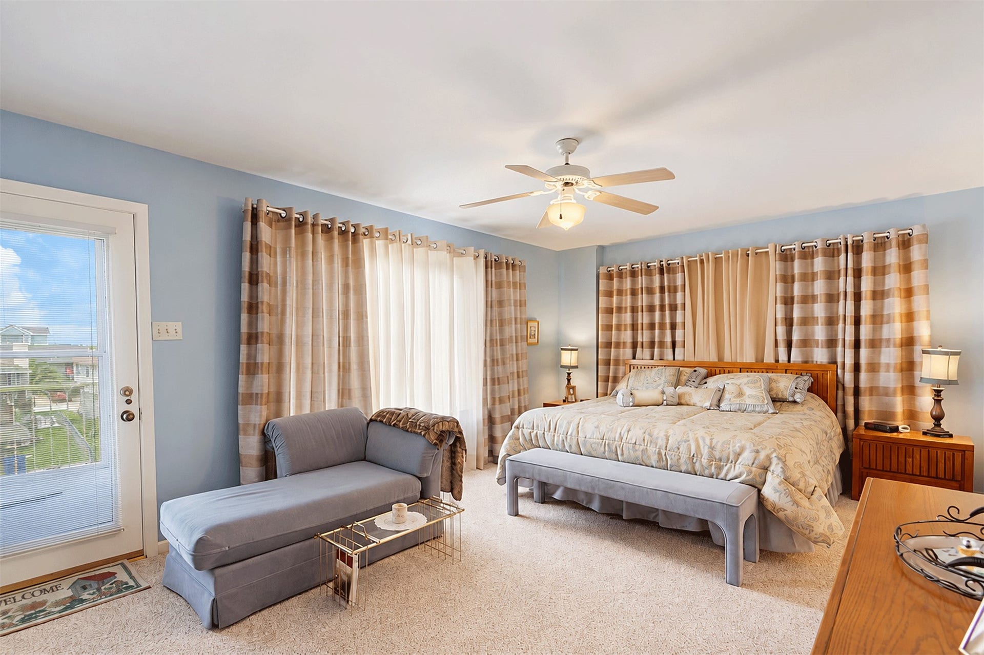 7 S Skimmer Street, La Marque, TX 77568 Primary bedroom with direct access to the deck and canal views.