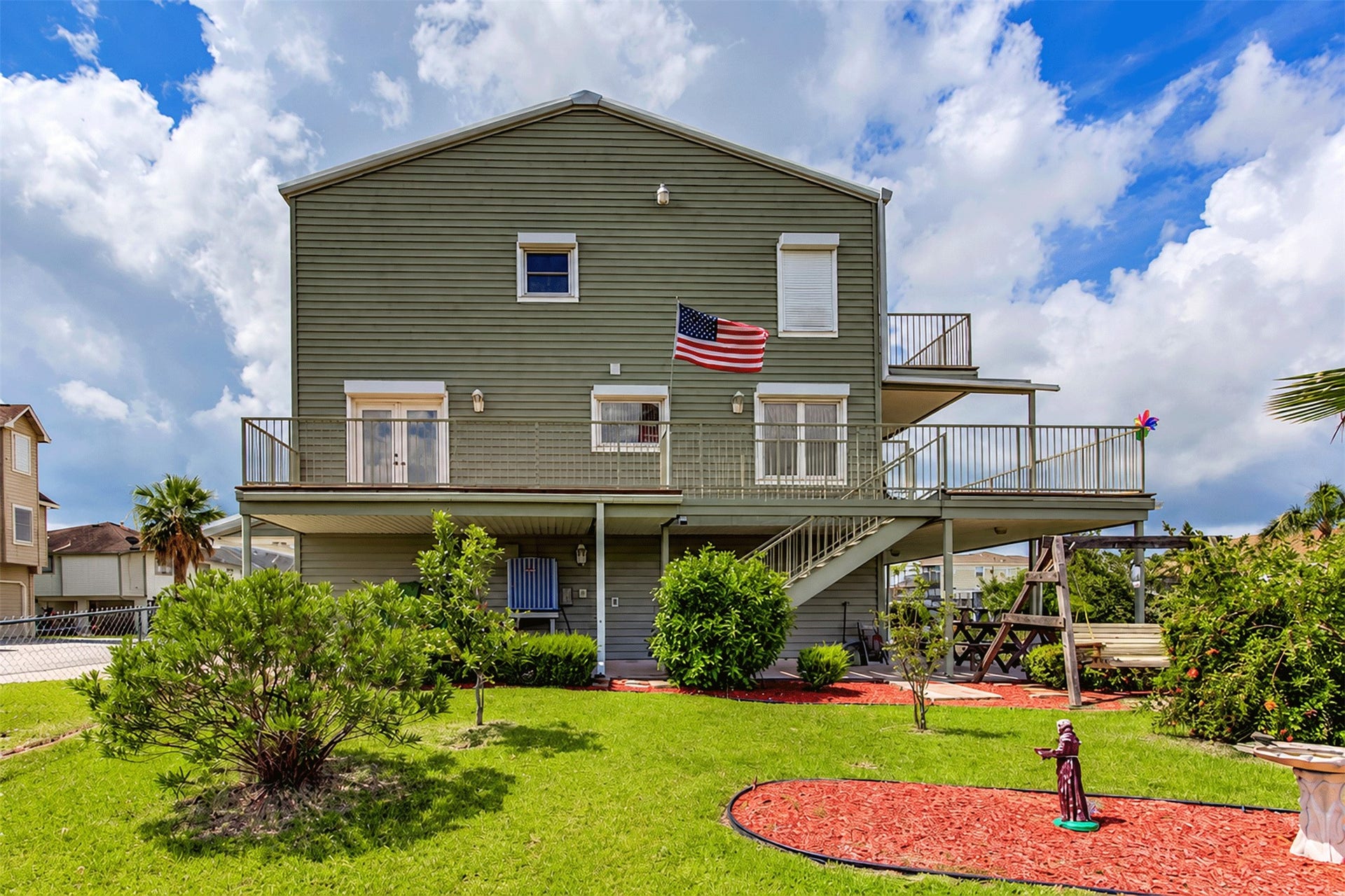 7 S Skimmer Street, La Marque, TX 77568 Waterside view of the home showing the wraparound decks on every level, perfect for enjoying the breeze.
