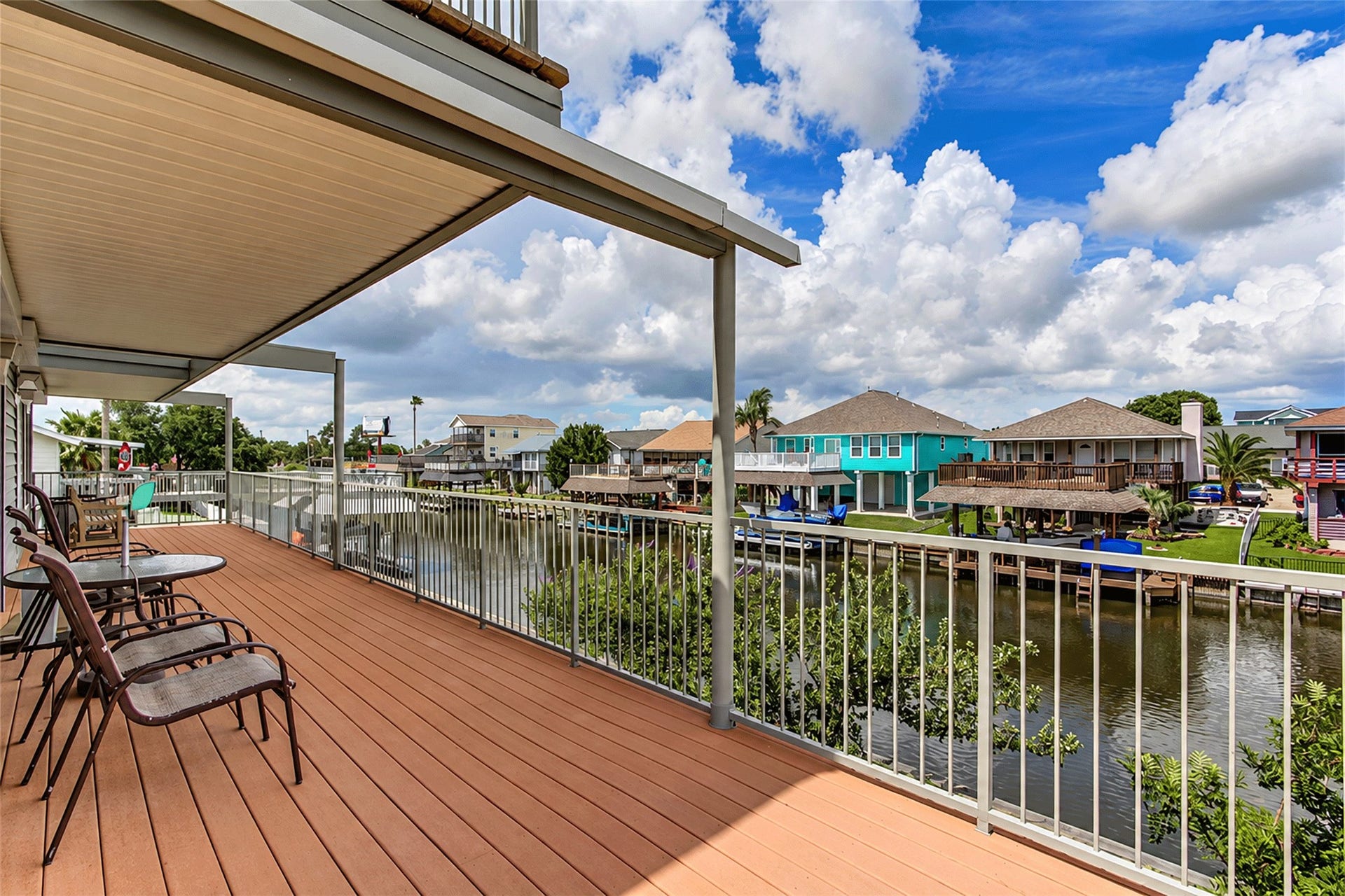 7 S Skimmer Street, La Marque, TX 77568 Covered deck with open canal views across the neighborhood.