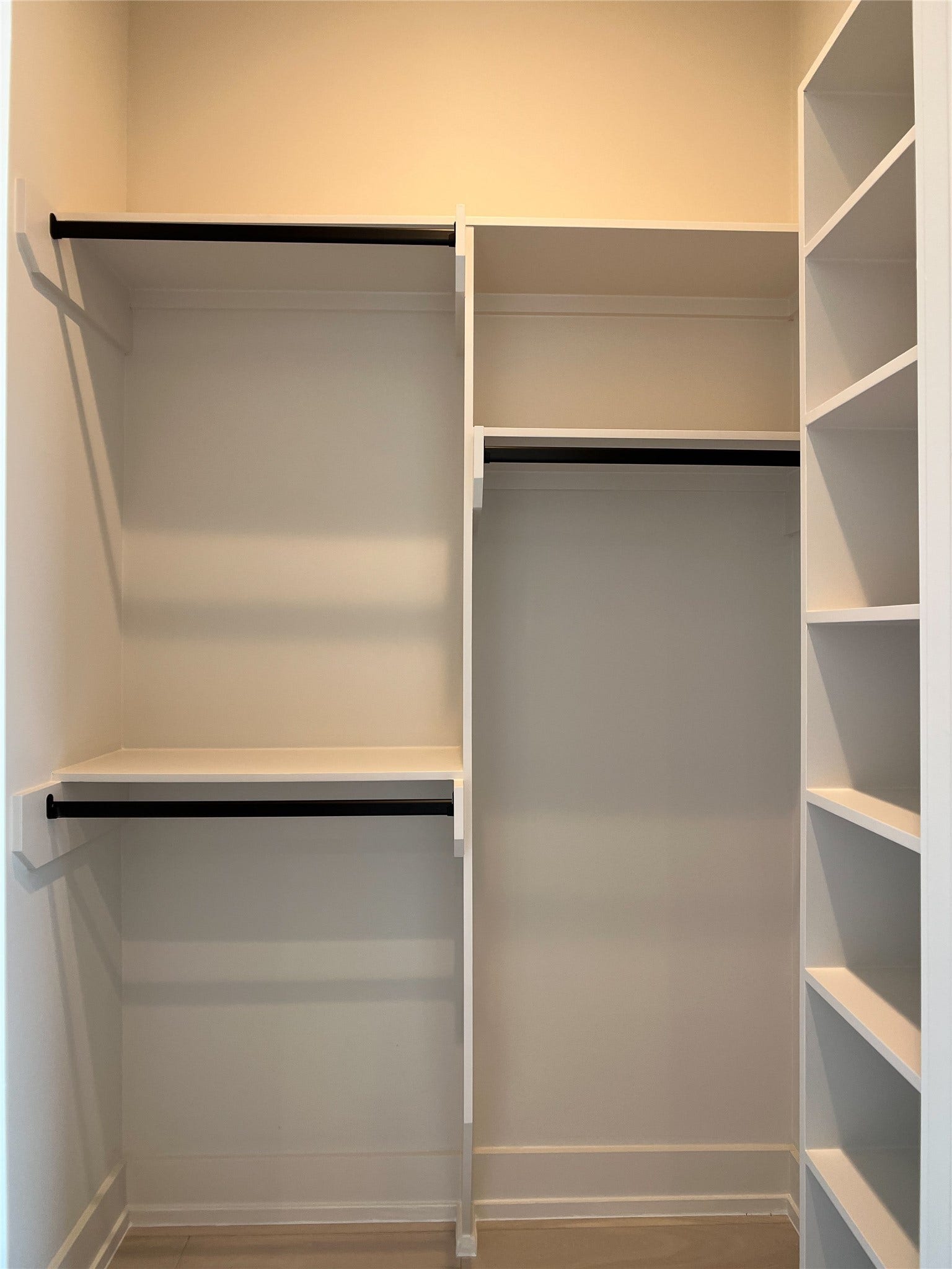 walk-in closet w/custom built-ins for 2nd of 2 secondary bedrooms