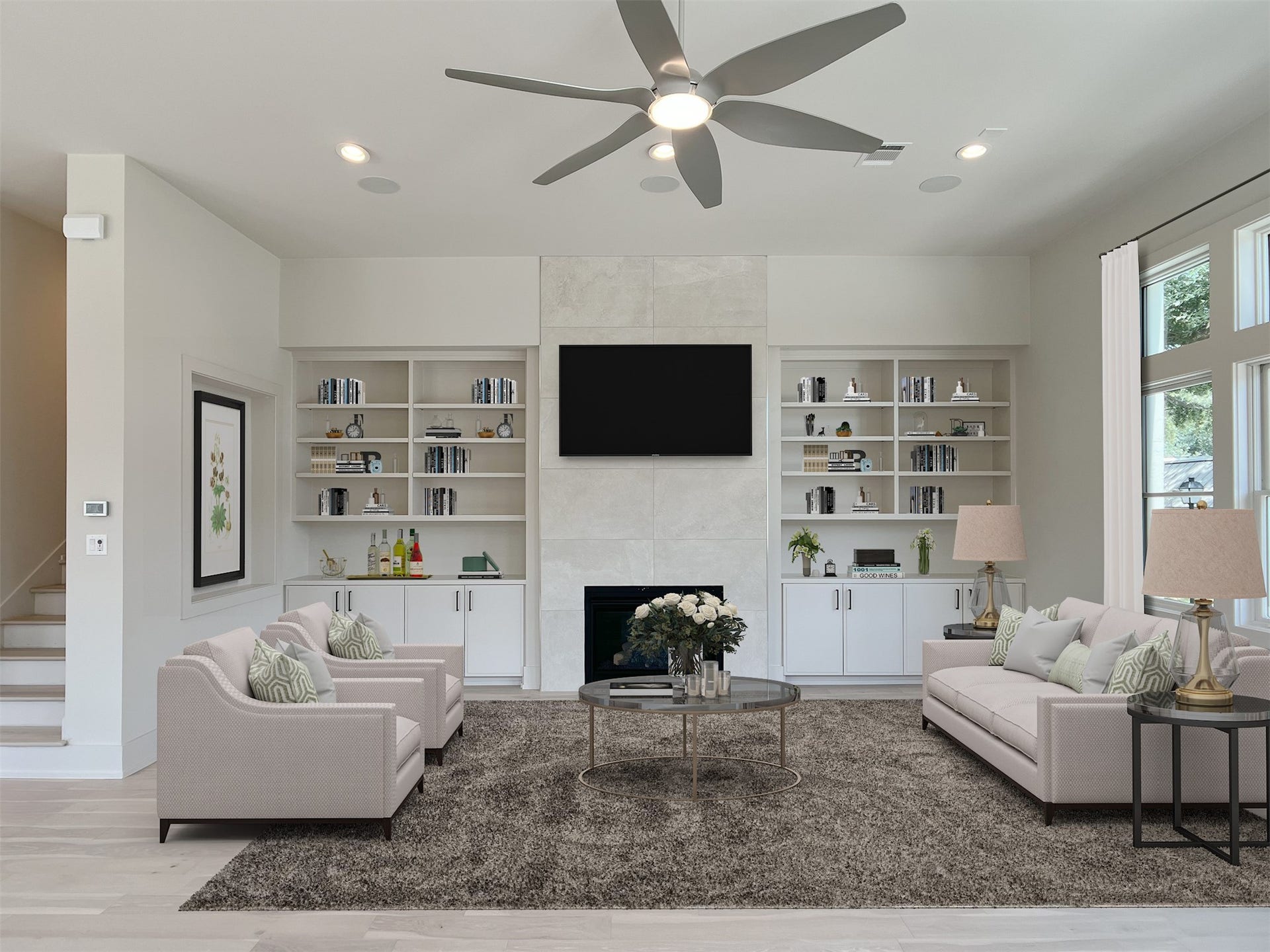 living room at front of home w/custom site-built cabinets & shelves flanking gorgeous tiled fireplace wall from floor to ceiling, art niche (virtually staged)