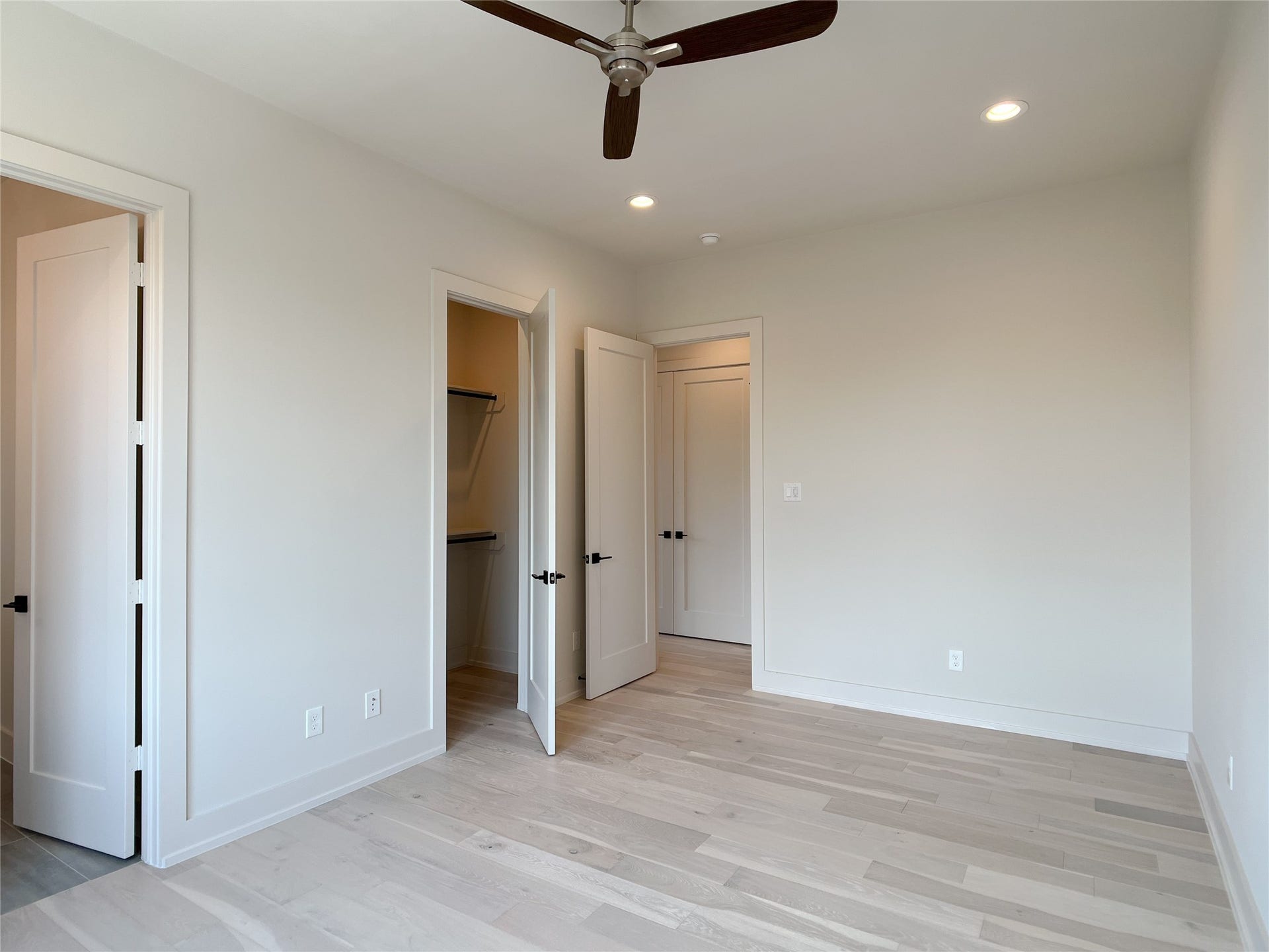contemporary ceiling fan, doors to bath & closet