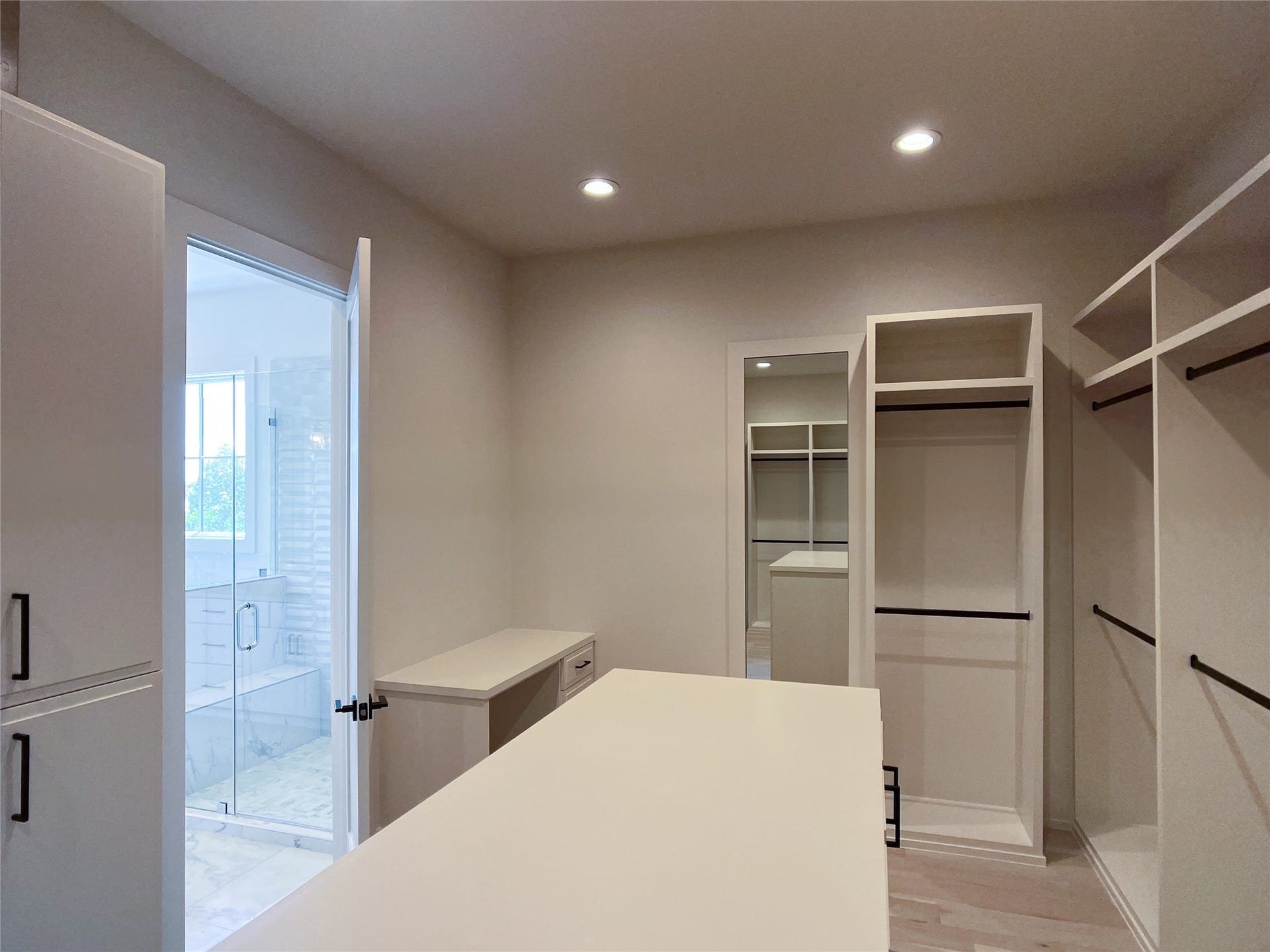 makeup vanity w/kneespace in corner; framed full-length mirror on wall
