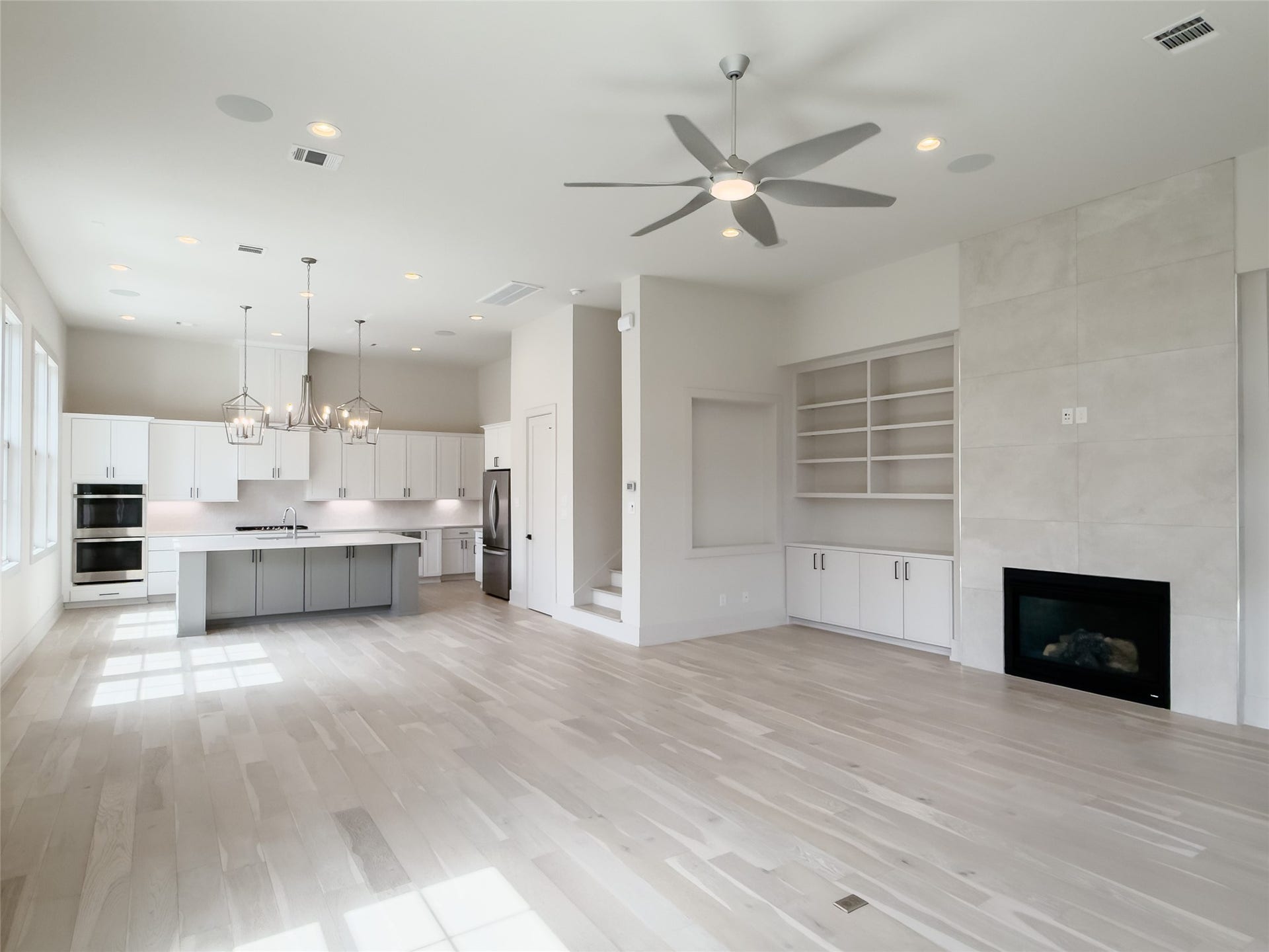 view from front door: serene color palette, 12' ceilings on 1st floor, light wood flooring
