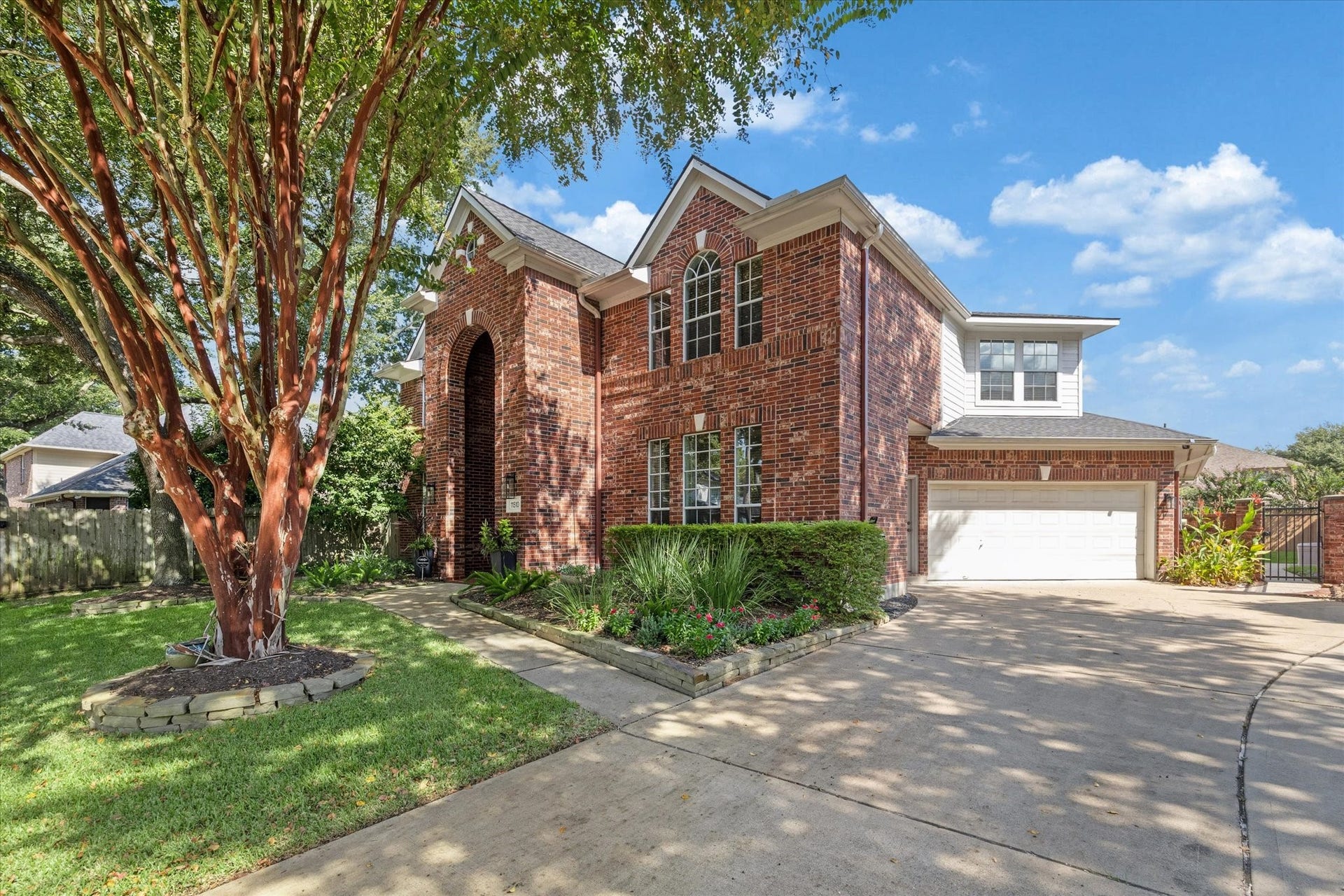 11510 Pecan Canyon Court, Tomball, TX 77377 Extra wide driveway with iron gate to the yard.