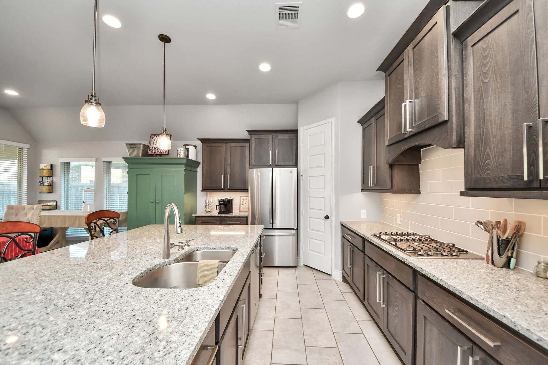 3211 Sweet Audrey Lane, Richmond, TX 77406 Undermount double sink on the island faces the family room so you stay part of the conversation.
