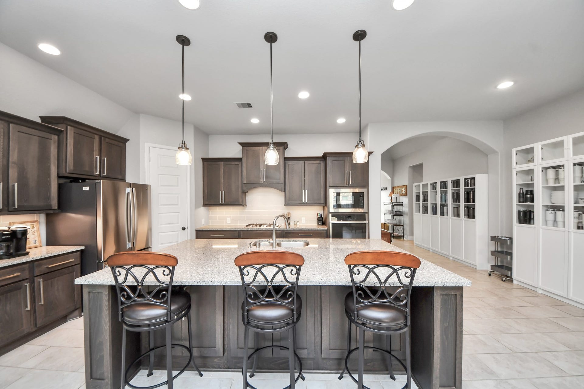 3211 Sweet Audrey Lane, Richmond, TX 77406 Large center island with seating for four, pendant lighting, and plenty of counter space for meal prep.