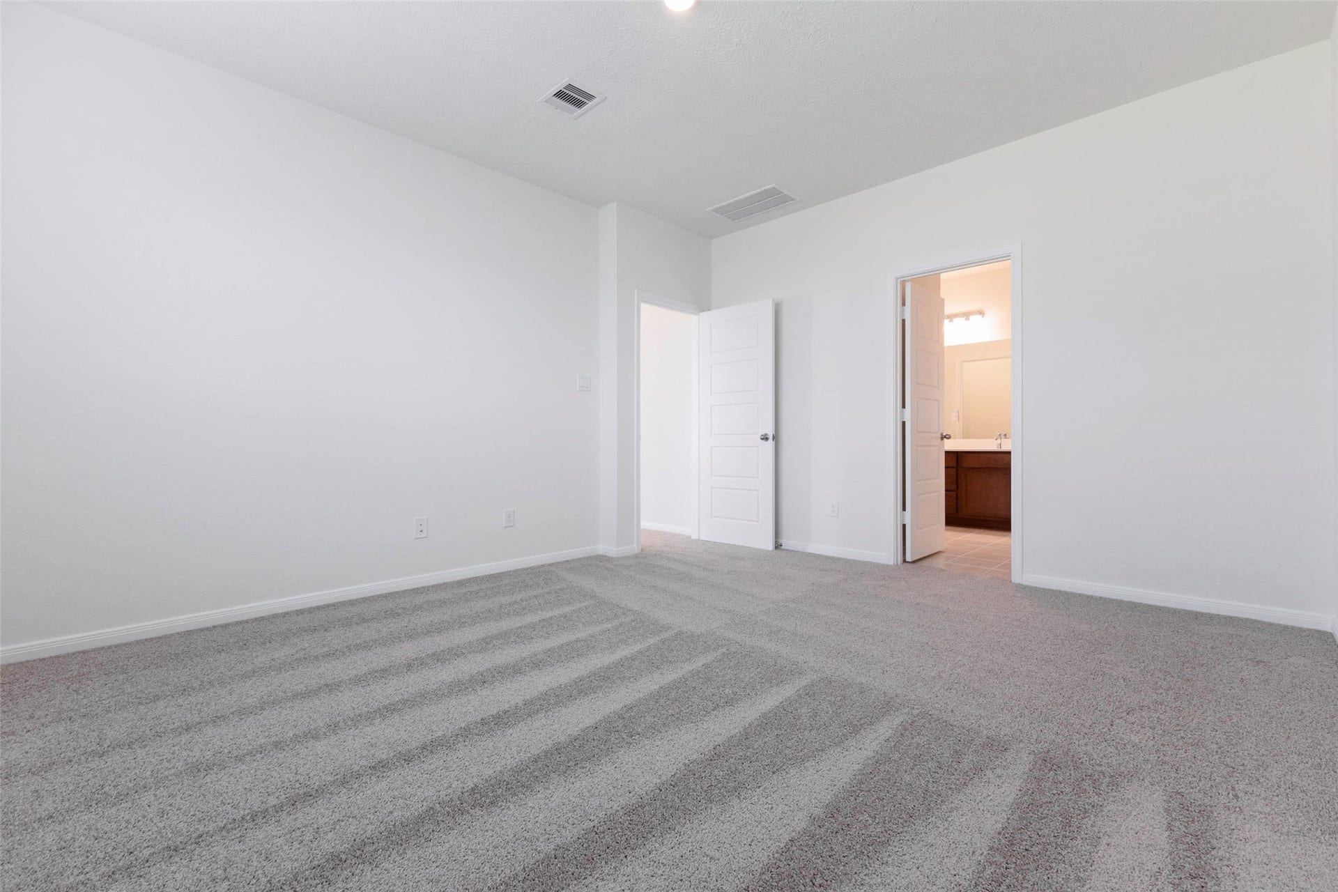 The primary suite offers direct access to the private bath.