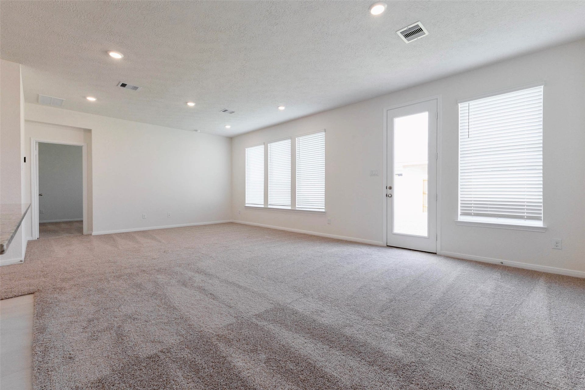 The family room opens directly to the backyard, keeping indoor and outdoor living connected.
