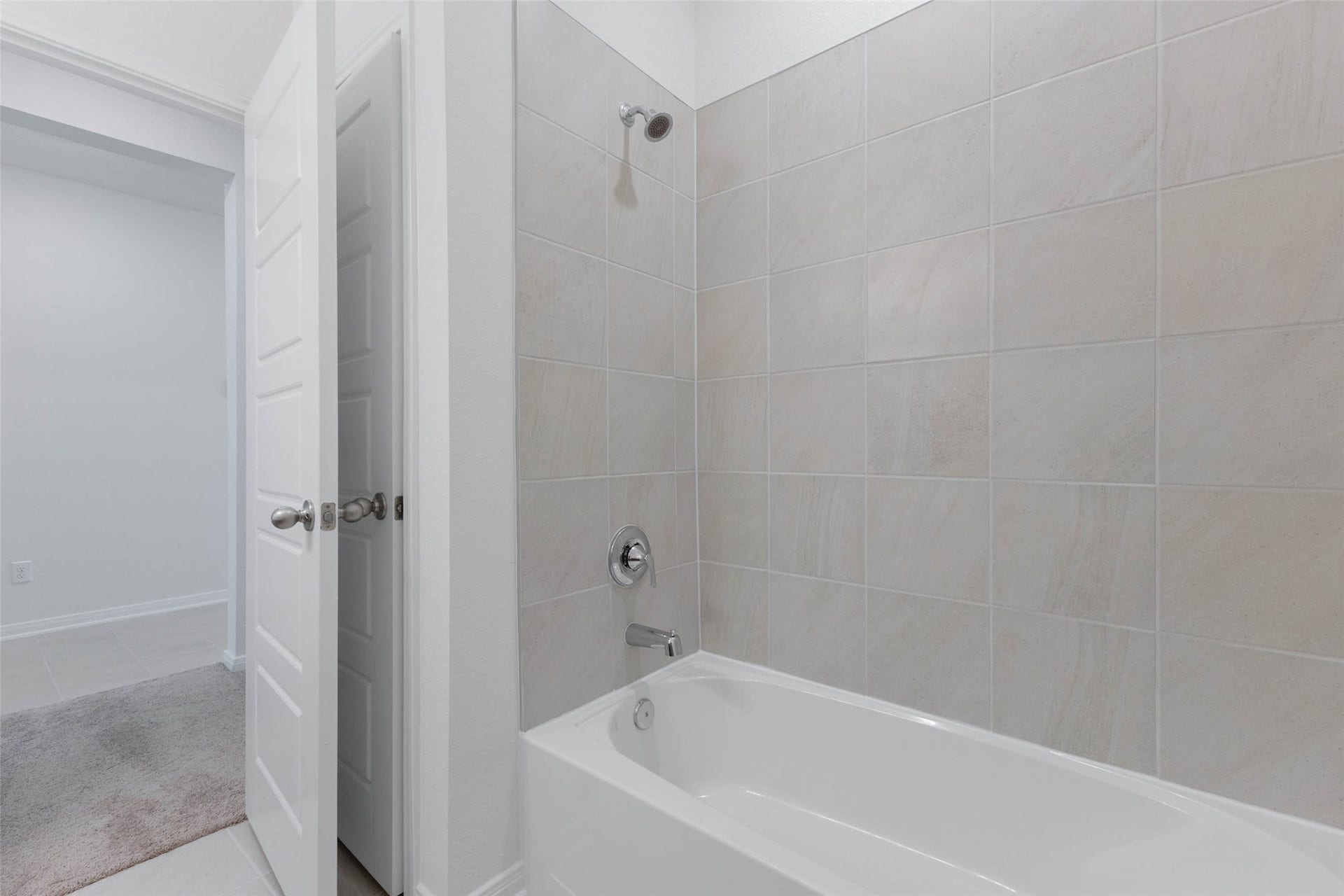 A tile surround tub and shower combo completes the secondary bath.