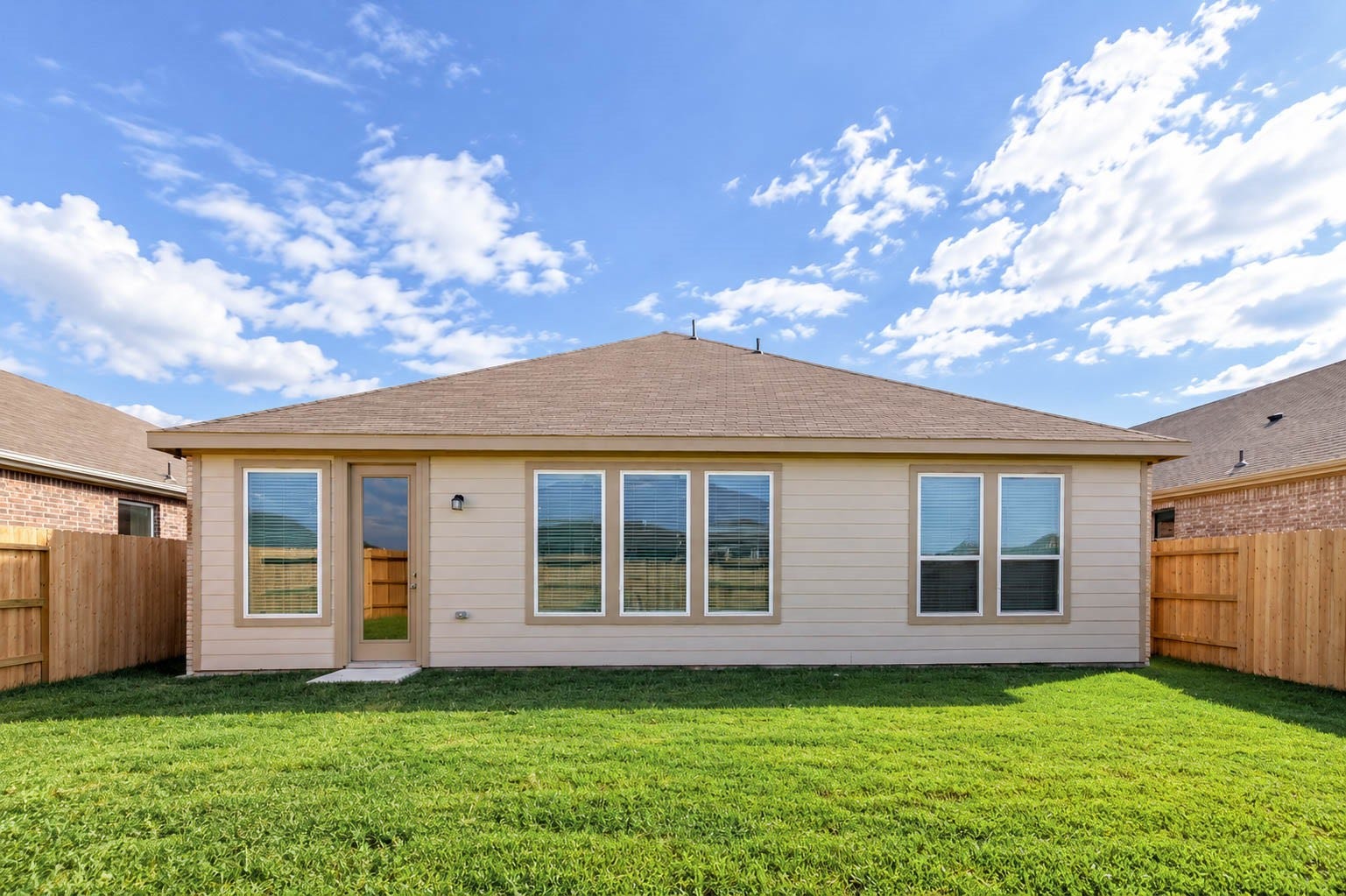 The fully fenced backyard offers a level lawn with room to play, garden or entertain.