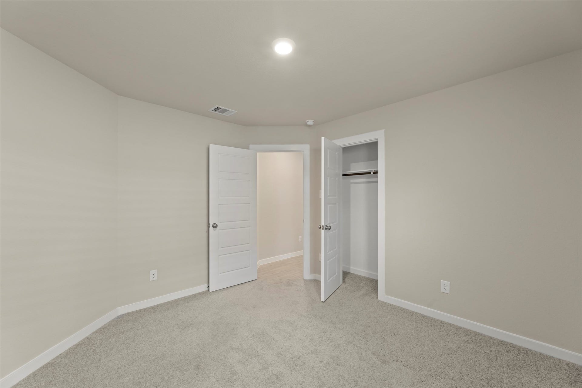 2610 Blue Abbot Drive, Fresno, TX 77545 Cozy bedroom with soft carpeting, neutral walls, and ample closet space, perfect for relaxation or study.