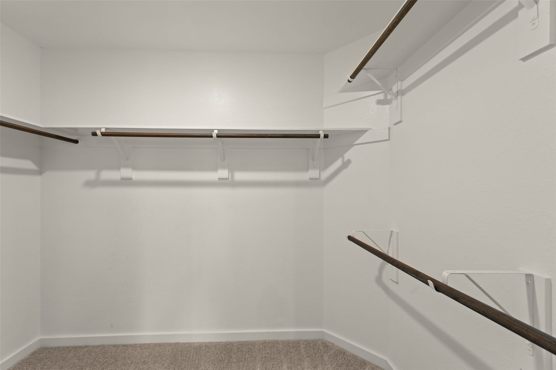 2610 Blue Abbot Drive, Fresno, TX 77545 Multiple hanging rods and clean white walls for ample storage.