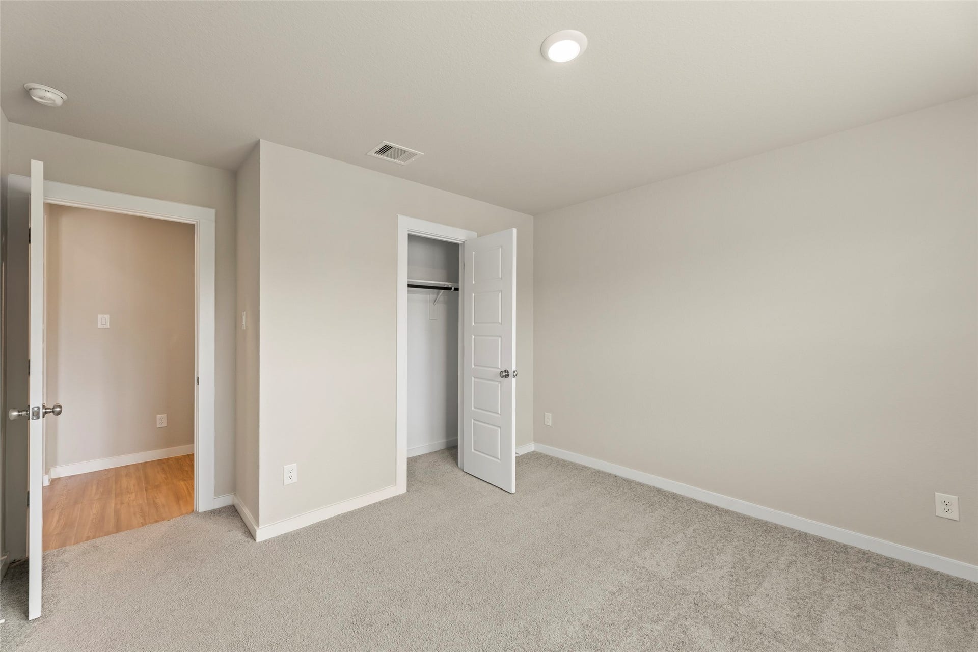 2610 Blue Abbot Drive, Fresno, TX 77545 Bright and inviting bedroom with neutral tones, soft carpeting, and a spacious closet, perfect for a cozy retreat.