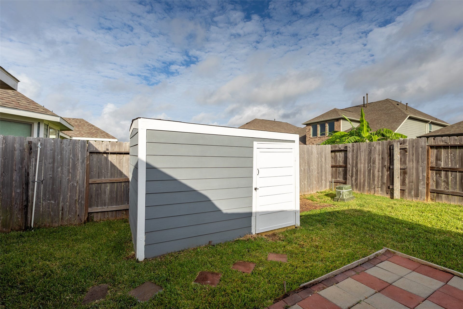 2610 Blue Abbot Drive, Fresno, TX 77545 Modern storage shed, and a privacy fence, perfect for outdoor activities and storage needs.