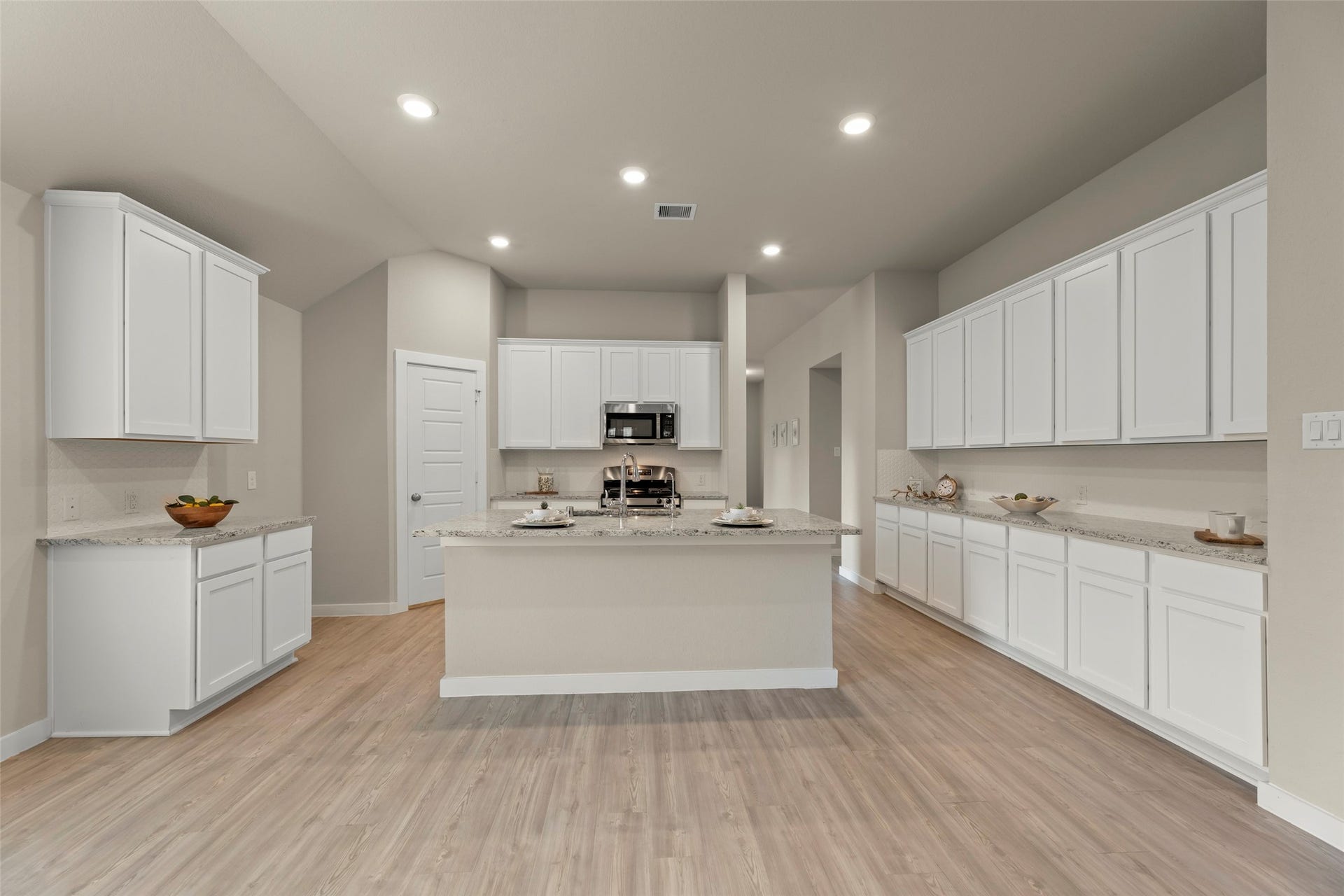 2610 Blue Abbot Drive, Fresno, TX 77545 Ample white cabinetry, sleek countertops, and an inviting island perfect for meal prep and entertaining.