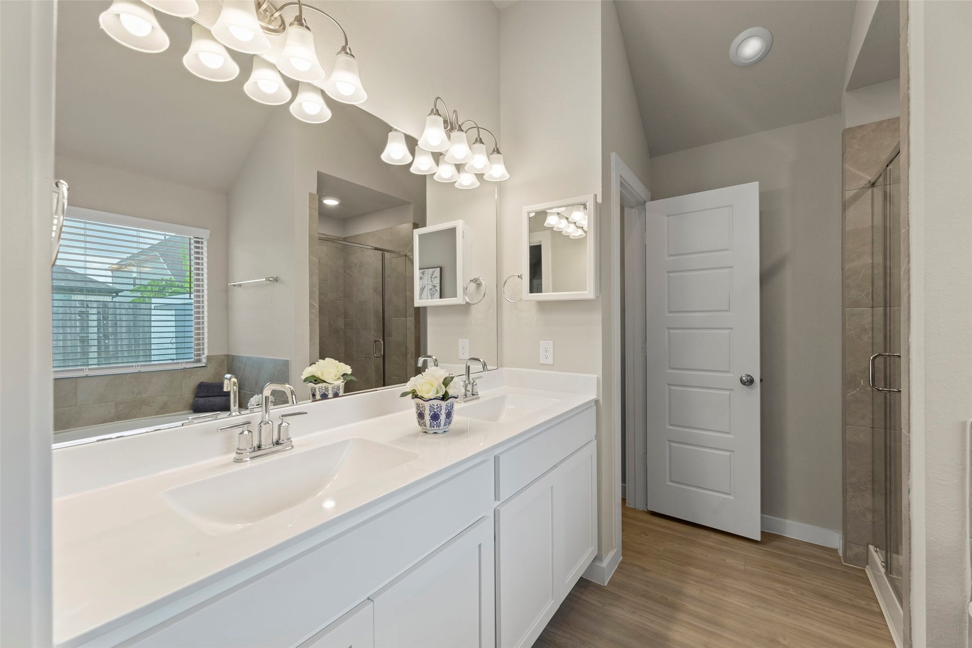 2610 Blue Abbot Drive, Fresno, TX 77545 Double vanity with modern fixtures, ample lighting, and a spacious walk-in shower.
