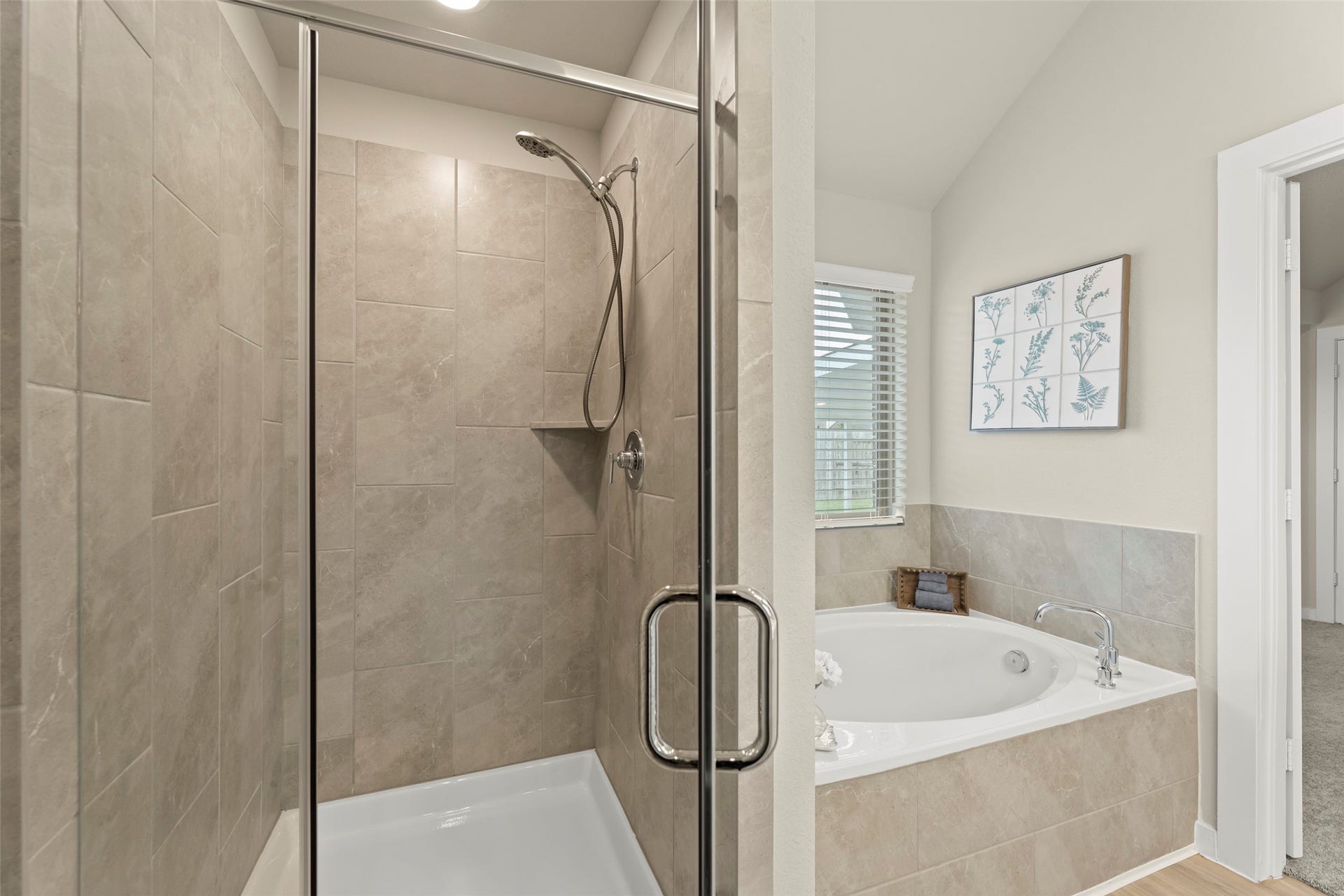 2610 Blue Abbot Drive, Fresno, TX 77545 Elegant bathroom featuring a spacious walk-in shower with sleek glass doors and a luxurious soaking tub, enhanced by natural light and tasteful decor.