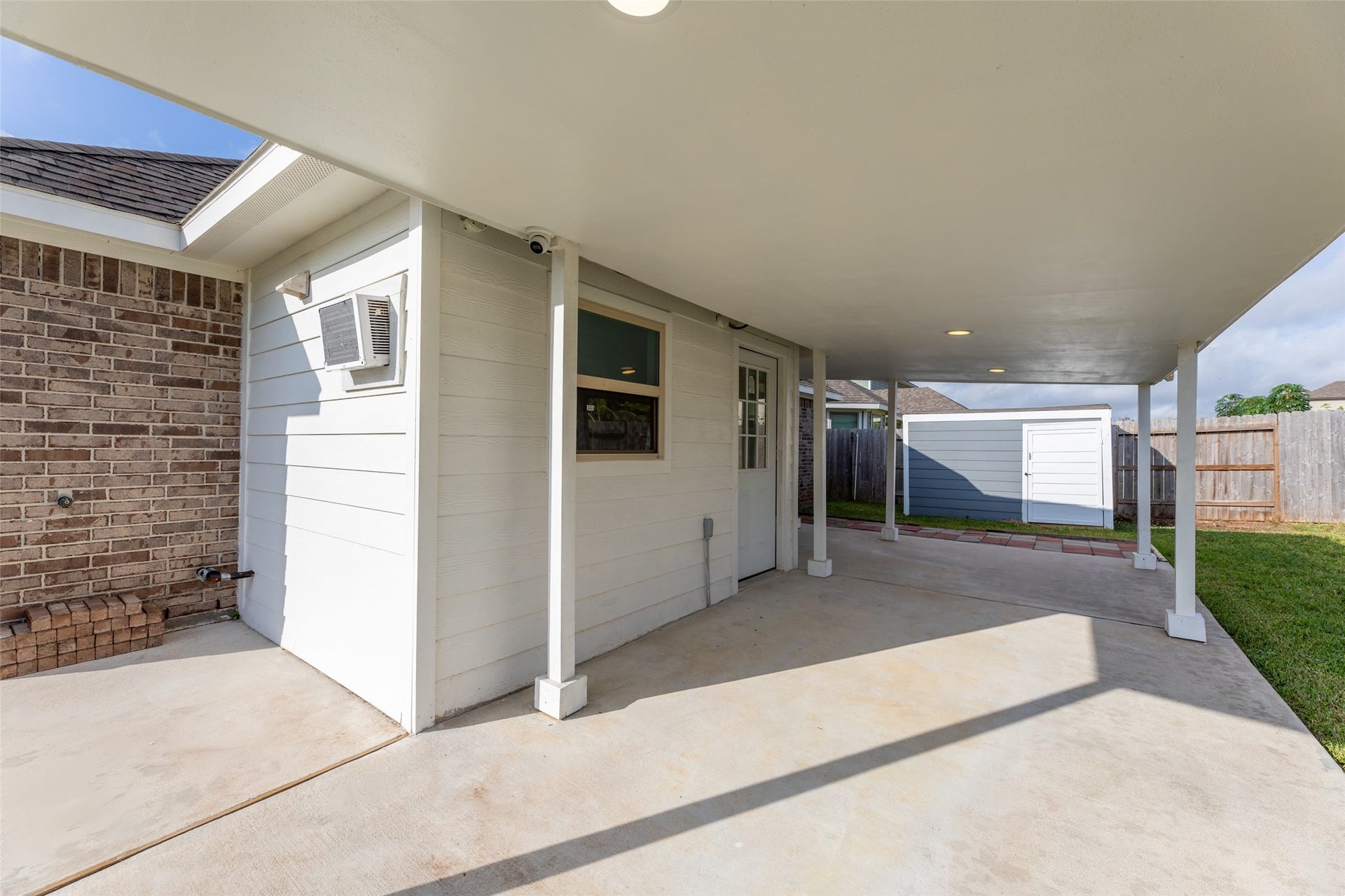 2610 Blue Abbot Drive, Fresno, TX 77545 Covered patio area perfect for outdoor relaxation, featuring a neatly maintained concrete surface and easy access to the backyard.