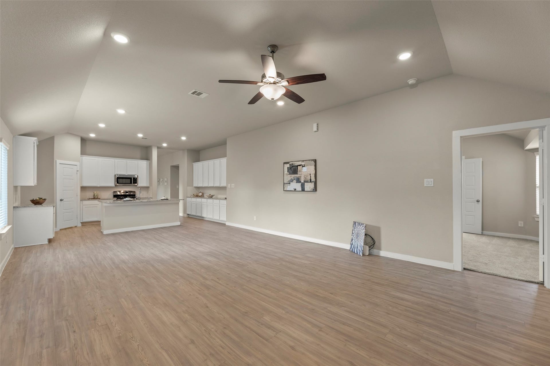 2610 Blue Abbot Drive, Fresno, TX 77545 Open-concept family room area with sleek wood flooring and recessed lighting.